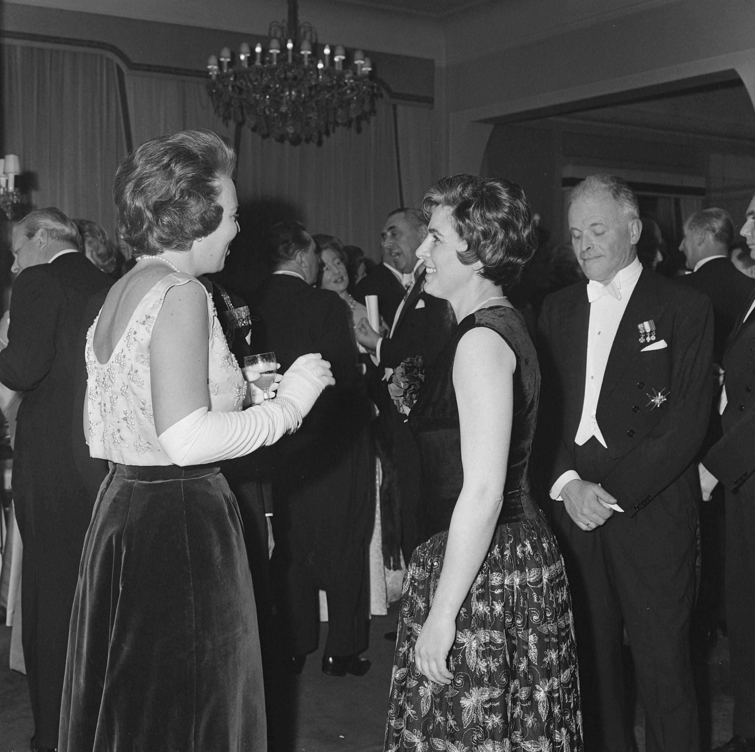 Fotocollectie Anefo — Prinses Beatrix en prinses Irene hebben in het Kurhaus te Scheveningen een galaconcert ter herdenking 150-jarig Koninkrijk bijgewoond. Prinses Beatrix wordt door burgemeester Kolfschoten in de pauze voorgesteld aan vrouwelijke aanwezige (mevr. Van Otterloo?). Achter deze chef-dirigent van het Residentie Orkest Willem van Otterloo — Foto: Koch, Eric / Anefo. Licentie: Set B: Rechtenvrij / Publiek Domein. Bron: Nationaal Archief. http://hdl.handle.net/10648/aa52ef38-d0b4-102d-bcf8-003048976d84