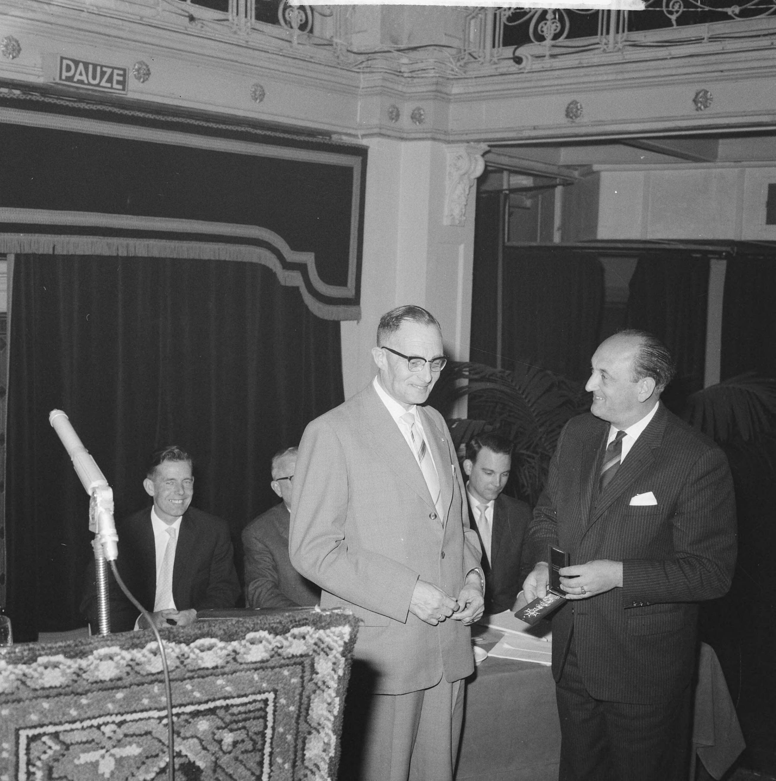 Fotocollectie Anefo — Jubileumcongres 50 jarig bestaan Vereniging van Nederlandse Gemeenten. Minister Toxopeus reikt een onderscheiding uit aan de financieel adviseur van de vereniging, J.W. van Dreven — Foto: Koch, Eric / Anefo. Licentie: Set B: Rechtenvrij / Publiek Domein. Bron: Nationaal Archief. http://hdl.handle.net/10648/aa0b6334-d0b4-102d-bcf8-003048976d84