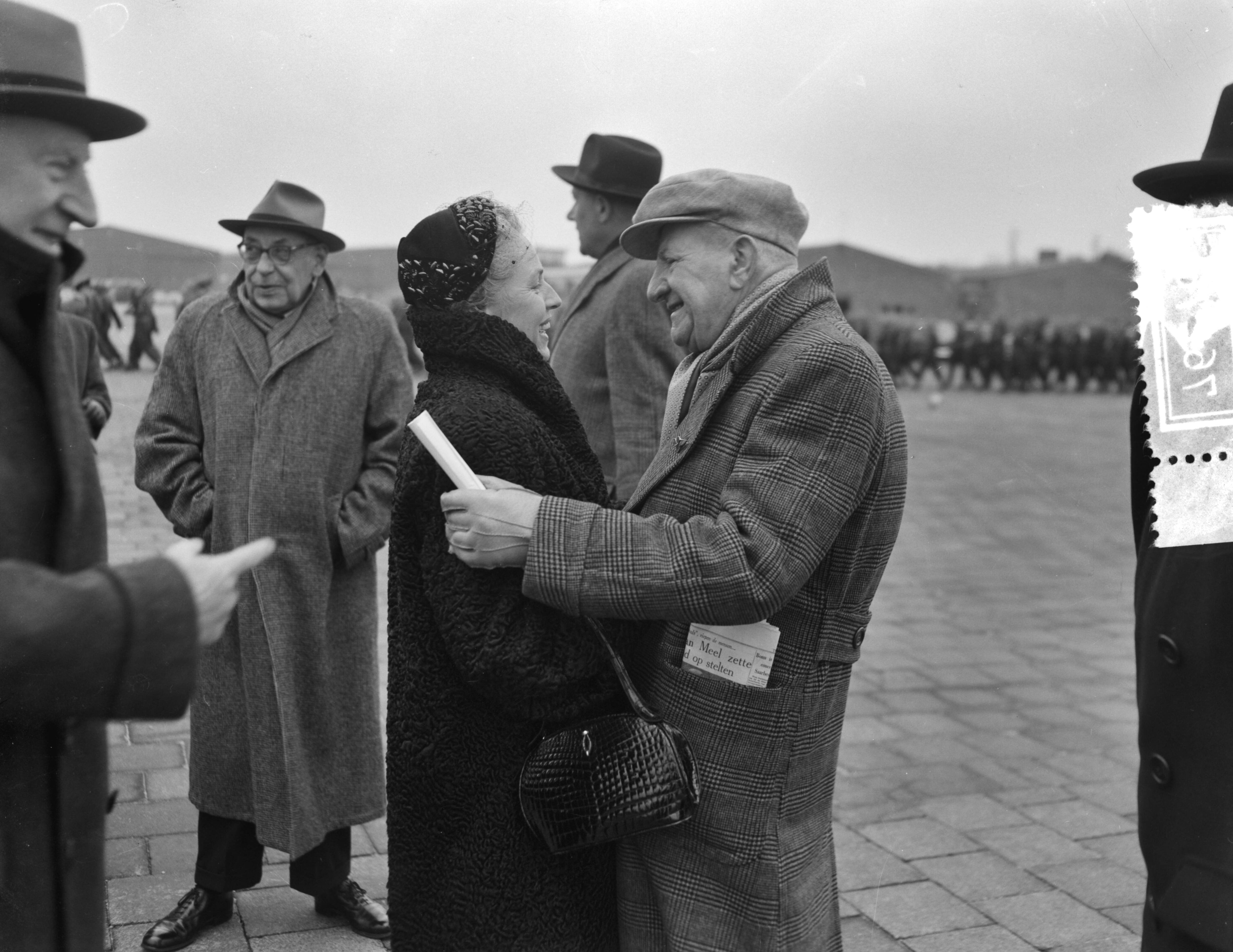 Fotocollectie Anefo — Groot militair vliegbrevet uitgereikt aan Nederlands eerste militaire vlieger, de 75-jarige Marinus van Meel. Van Meel wordt gefeliciteerd door zijn echtgenote? — Foto: Rossem, Wim van / Anefo. Licentie: Set B: Rechtenvrij / Publiek Domein. Bron: Nationaal Archief. http://hdl.handle.net/10648/ad773624-d0b4-102d-bcf8-003048976d84