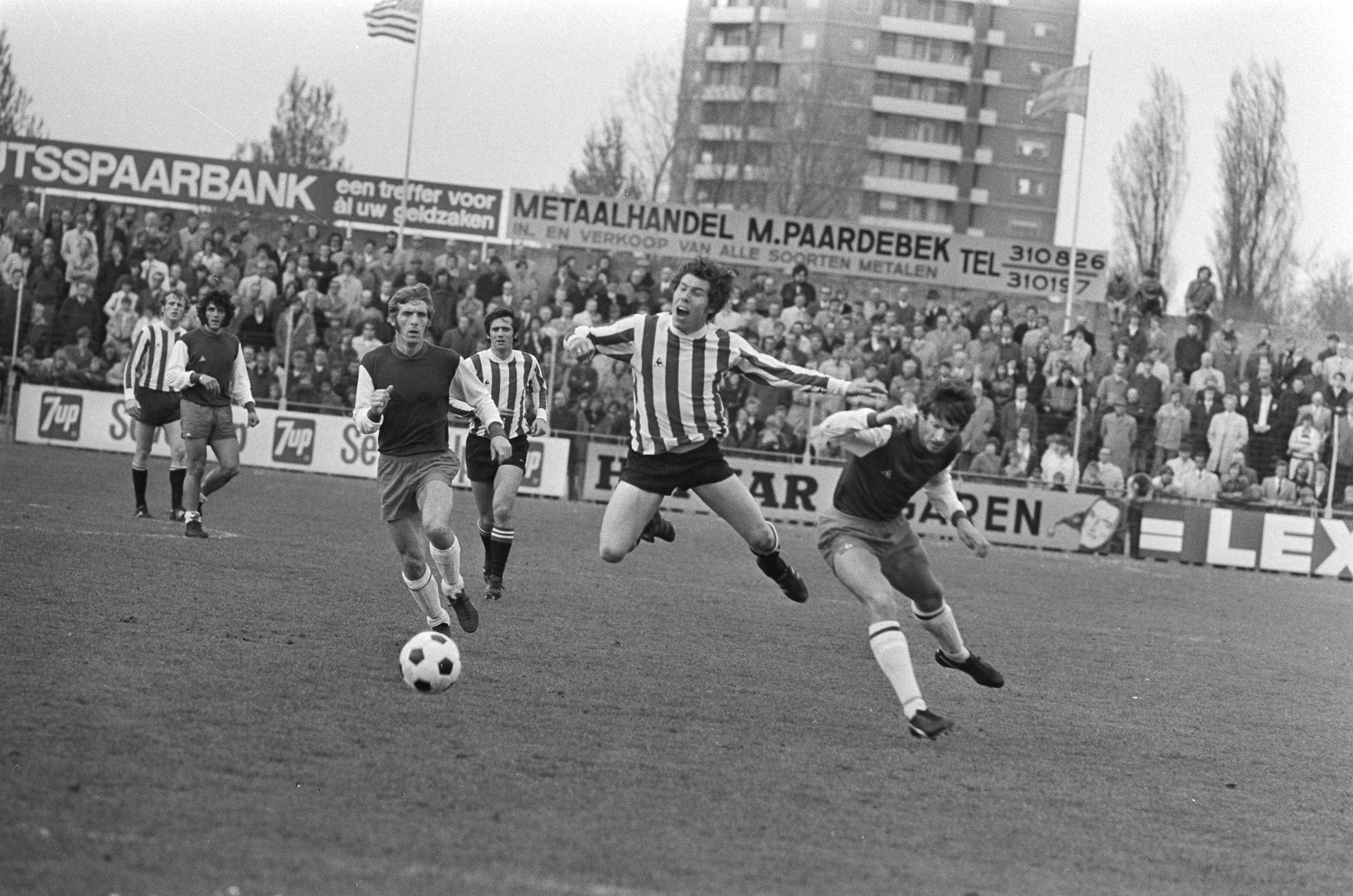 Voetbalwedstrijd eredivisie Haarlem - PSV: 1-3 — PSV-speler Veenstra (m) wordt ten val gebracht door Wentink, De Haan (l) — Foto: Fotograaf Onbekend / Anefo. Licentie: Set B: Rechtenvrij / Publiek Domein. Bron: Nationaal Archief. http://hdl.handle.net/10648/abbcb82c-d0b4-102d-bcf8-003048976d84