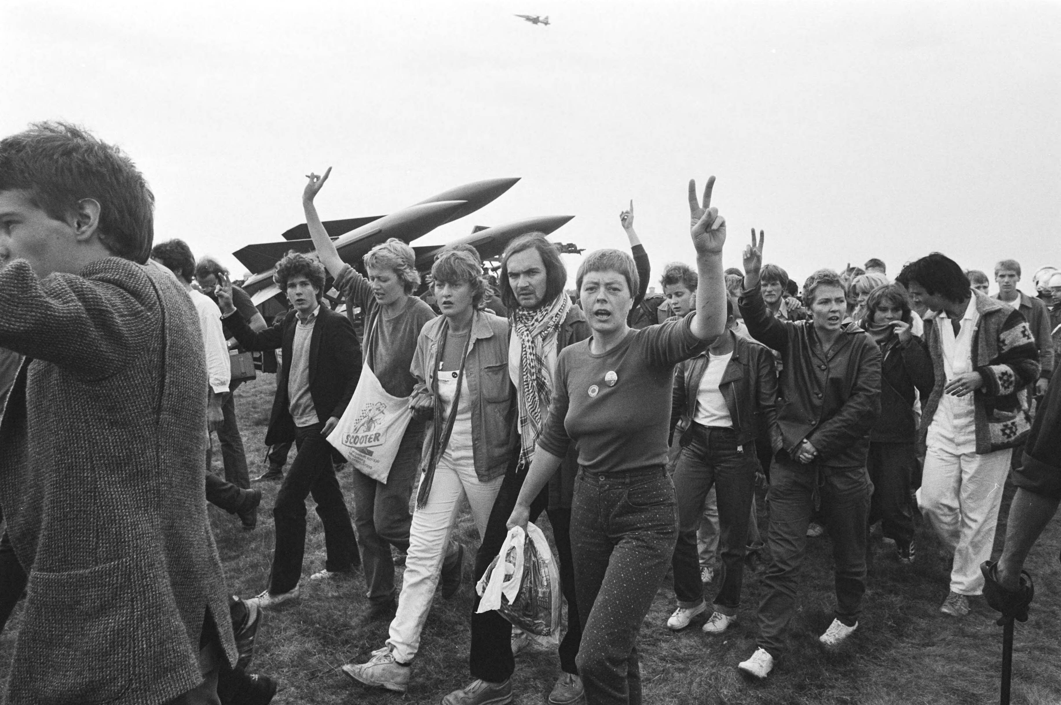 Open dag op luchtmachtbasis Soesterberg — Leden van aktiegroep "Onkruit" demonstreerden tegen de krijgsmacht op de open dag op de luchtmachtbasis Soesterberg — Foto: Dijk, Hans van / Anefo. Licentie: Set B: Rechtenvrij / Publiek Domein. Bron: Nationaal Archief. http://hdl.handle.net/10648/ad03980e-d0b4-102d-bcf8-003048976d84
