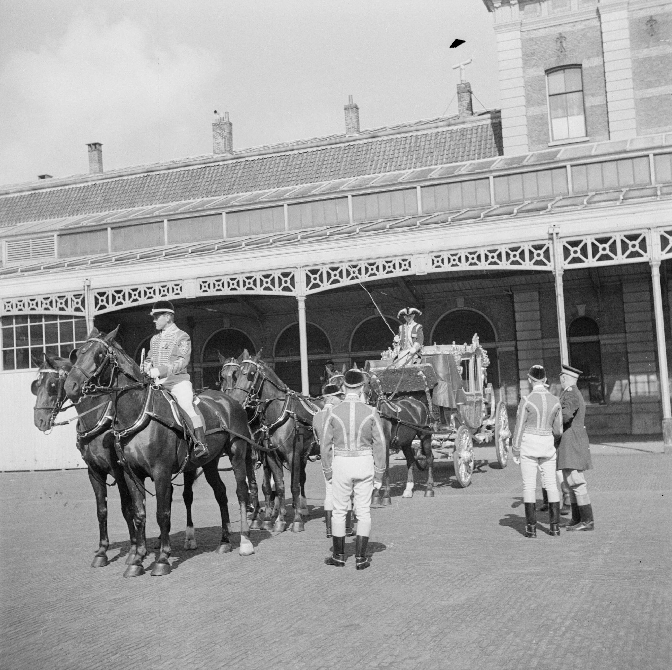 Troonsafstand koningin Wilhelmina / Inhuldiging van koningin Juliana — Voorbereidingen. Repetitie met de Gouden Koets op de binnenplaats van het Koninklijk Staldepartement in Den Haag. — Foto: Poll, Willem van de. Licentie: Set B: Rechtenvrij / Publiek Domein. Bron: Nationaal Archief. http://hdl.handle.net/10648/aee7e33c-d0b4-102d-bcf8-003048976d84