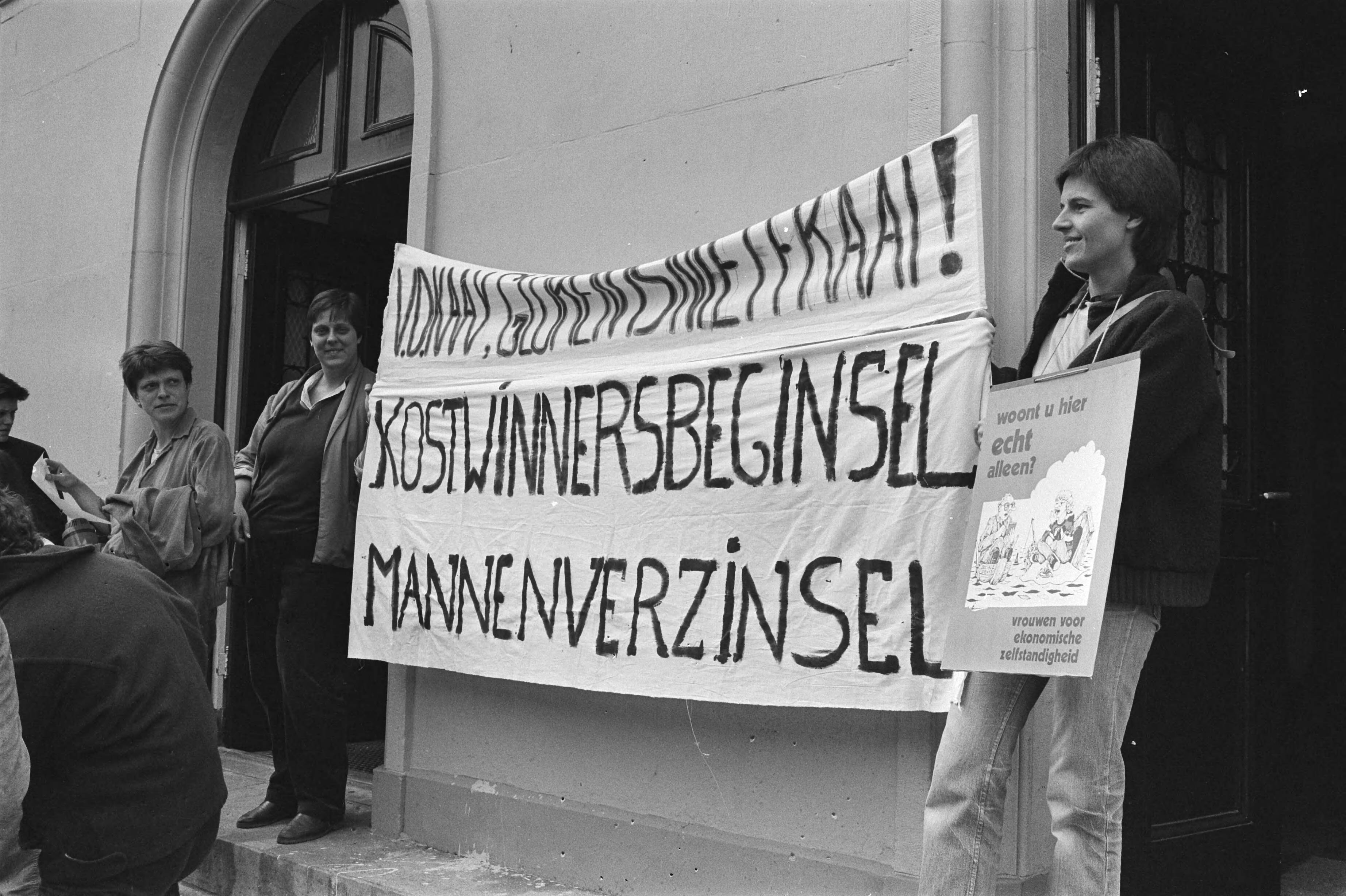 Fotocollectie Anefo — Amsterdam, kort geding Albine Grumbock tegen haar buurman dir. Sociale Dienst Edam; vrouwen demonstreren voor gerechtsgebouw tegen het kostwinnersbeginsel / — Foto: Antonisse, Marcel / Anefo. Licentie: Set B: Rechtenvrij / Publiek Domein. Bron: Nationaal Archief. http://hdl.handle.net/10648/ad384f22-d0b4-102d-bcf8-003048976d84
