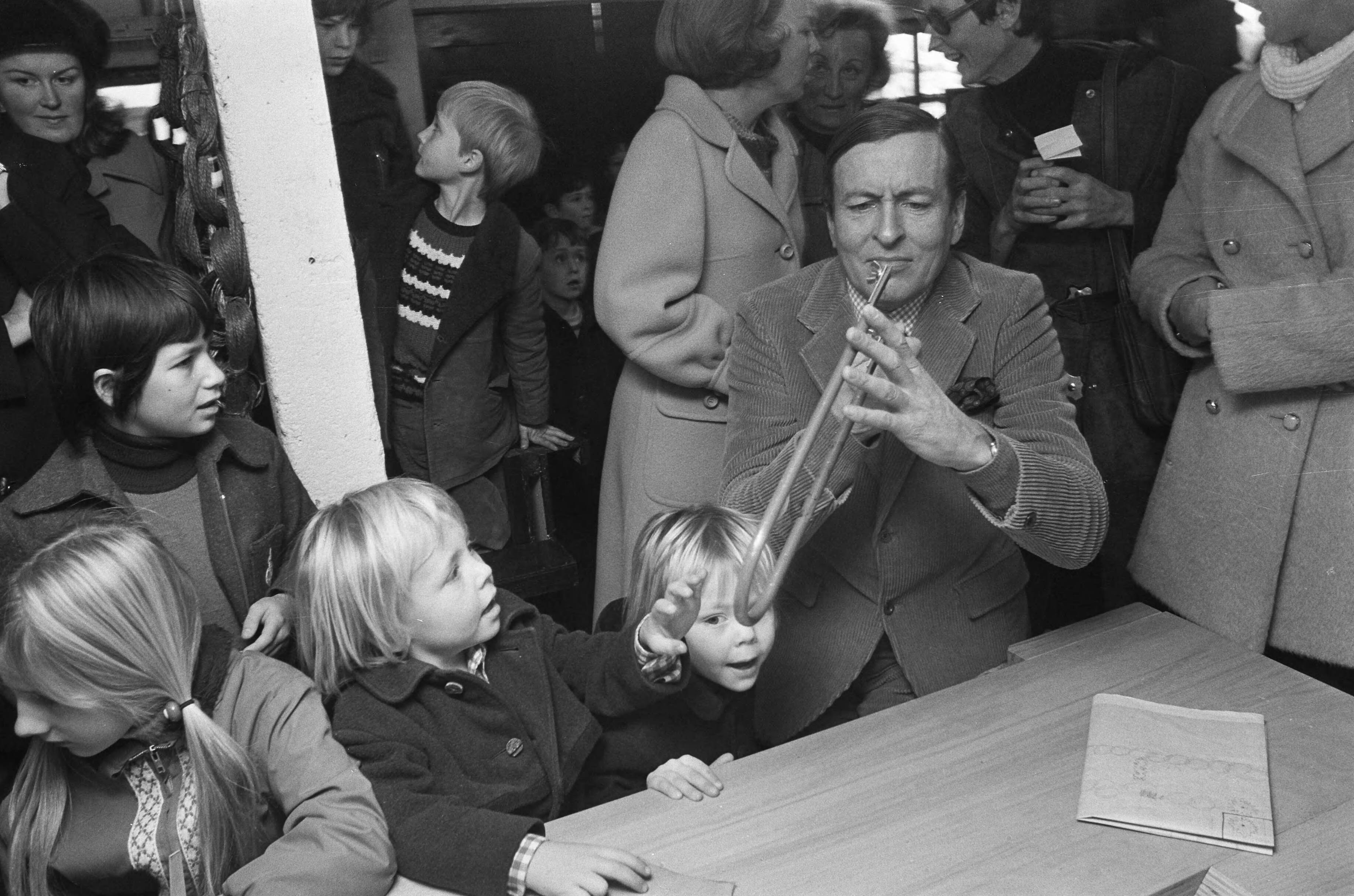 Prinses Beatrix en Prins Claus met hun kinderen bij de opening van kinderboerderij "De Vrije Teugel" in Soest — Prins Claus maakt een grapje bij het figuurzagen, Johan Friso en Constantijn kijken toe — Foto: Fotograaf Onbekend / Anefo. Licentie: Set B: Rechtenvrij / Publiek Domein. Bron: Nationaal Archief. http://hdl.handle.net/10648/ac3cad16-d0b4-102d-bcf8-003048976d84