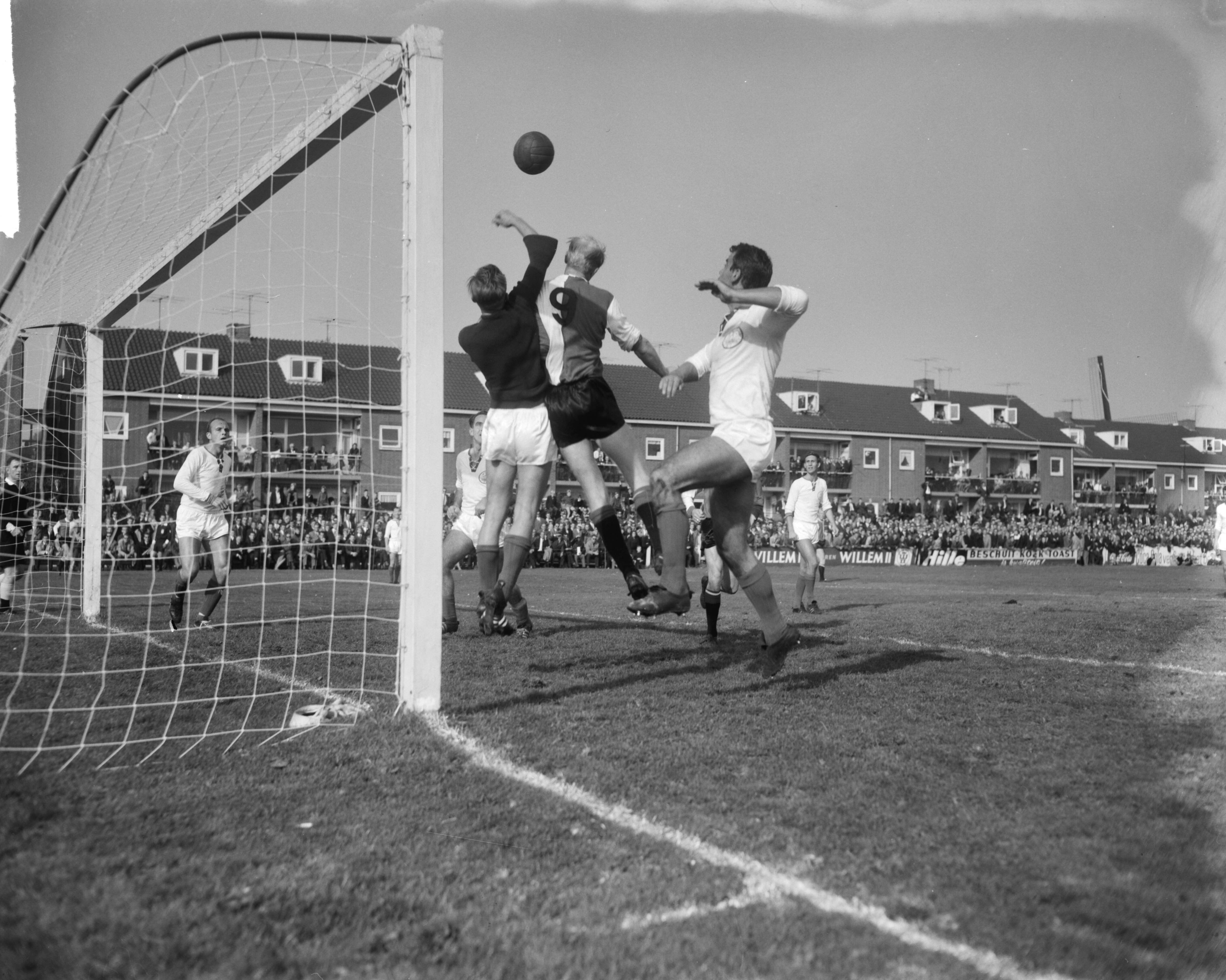 Fotocollectie Anefo — Voetbal. 1e ronde KNVB-beker. FC Zaanstreek tegen Feijenoord 1-2. Spelmoment voor het doel van FC Zaanstreek, luchtduel tussen Zaanstreek-keeper en Piet Kruiver (Feijenoord) — Foto: Bilsen, Joop van / Anefo. Licentie: Set B: Rechtenvrij / Publiek Domein. Bron: Nationaal Archief. http://hdl.handle.net/10648/aa7c9f9a-d0b4-102d-bcf8-003048976d84