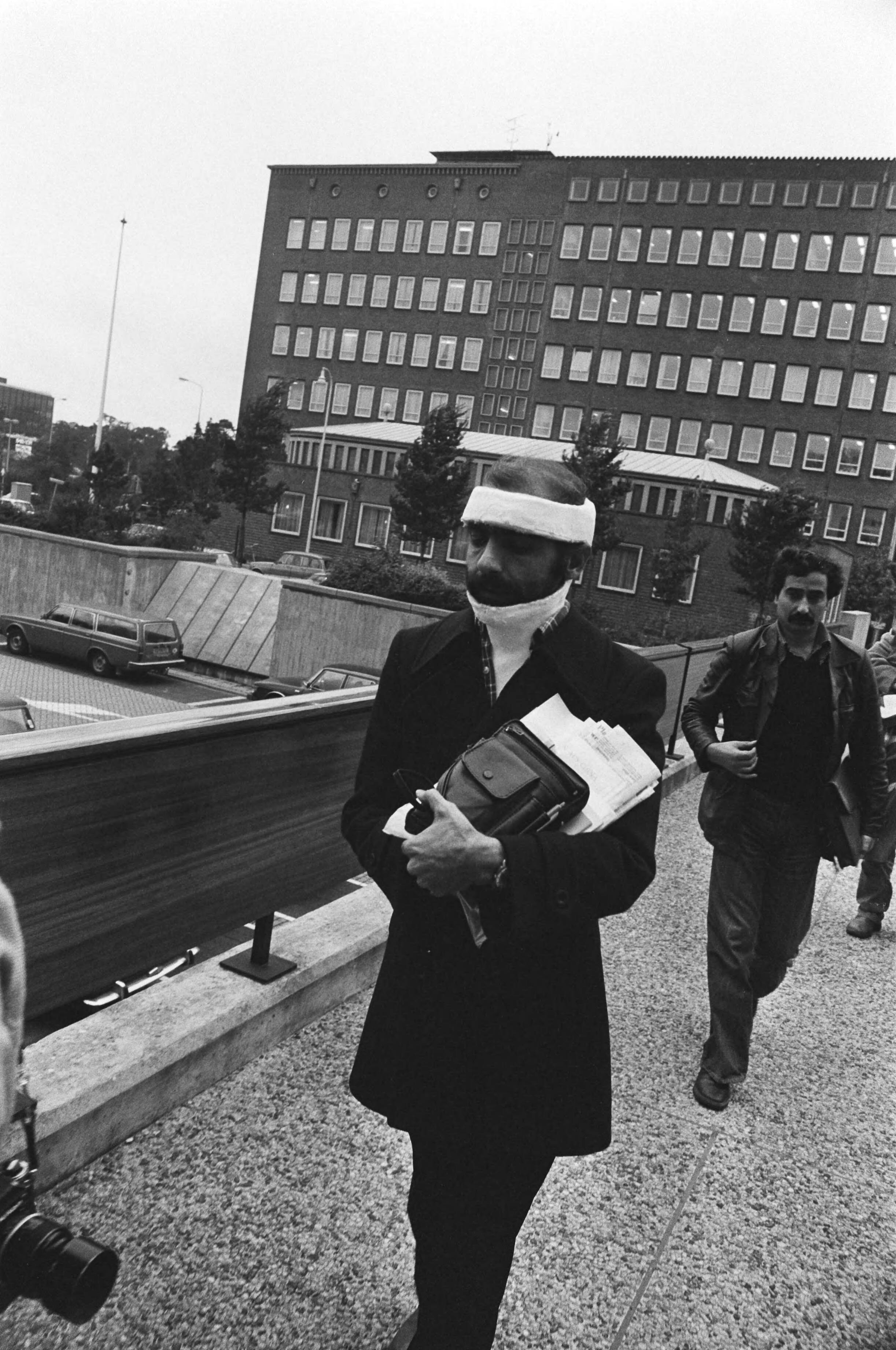 Fotocollectie Anefo — Iraanse studenten (bezetters Wassenaar) met spandoeken bij hun proces (Den Haag); Iran in gips na politiebehandeling — Foto: Bogaerts, Rob / Anefo. Licentie: Set B: Rechtenvrij / Publiek Domein. Bron: Nationaal Archief. http://hdl.handle.net/10648/acbd084e-d0b4-102d-bcf8-003048976d84