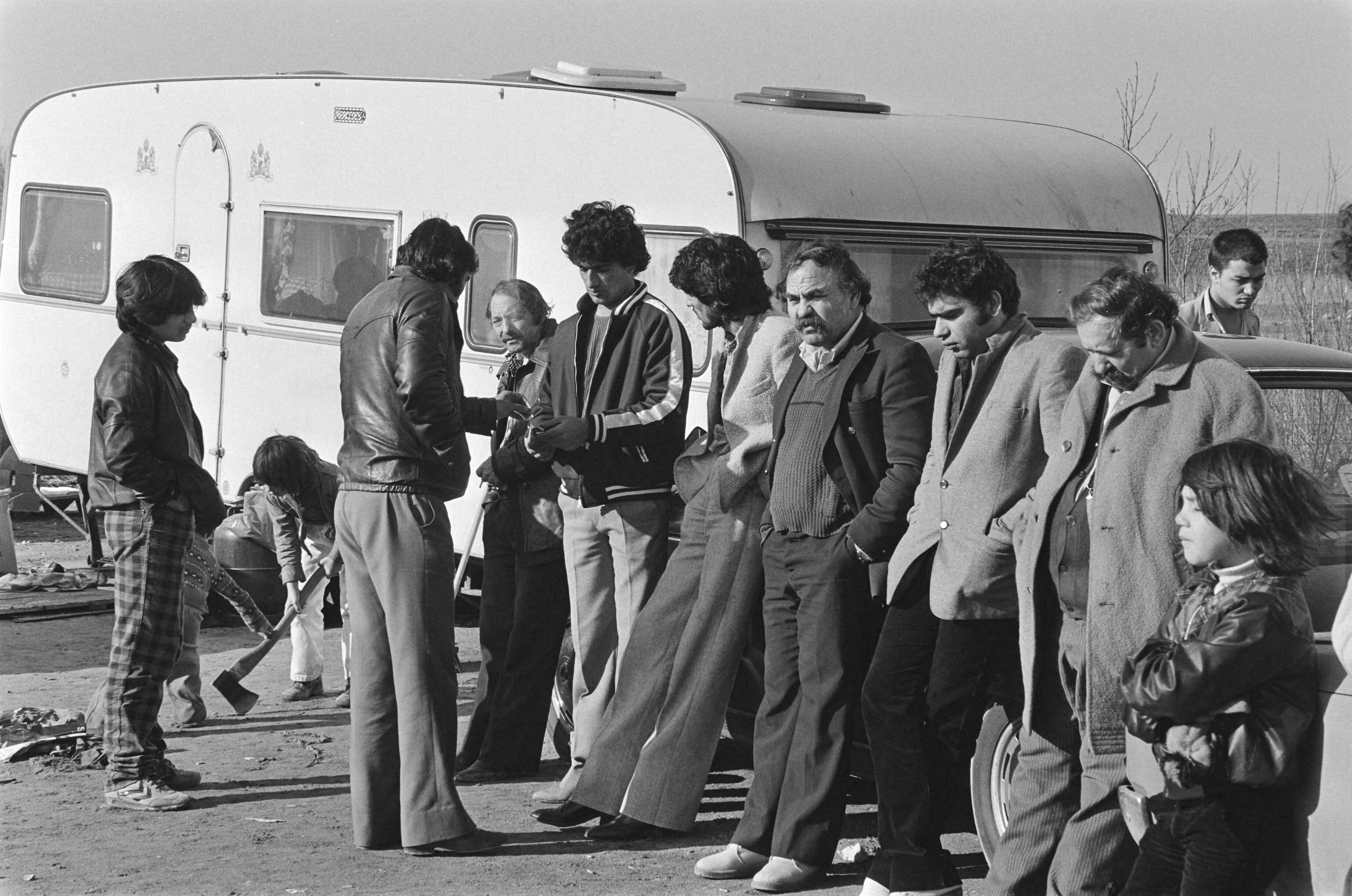 Fotocollectie Anefo — Honderd zigeuners verblijven voorlopig op camping in Almere groepje zigeunermannen op de camping — Foto: Dijk, Hans van / Anefo. Licentie: Set B: Rechtenvrij / Publiek Domein. Bron: Nationaal Archief. http://hdl.handle.net/10648/acf4cde2-d0b4-102d-bcf8-003048976d84