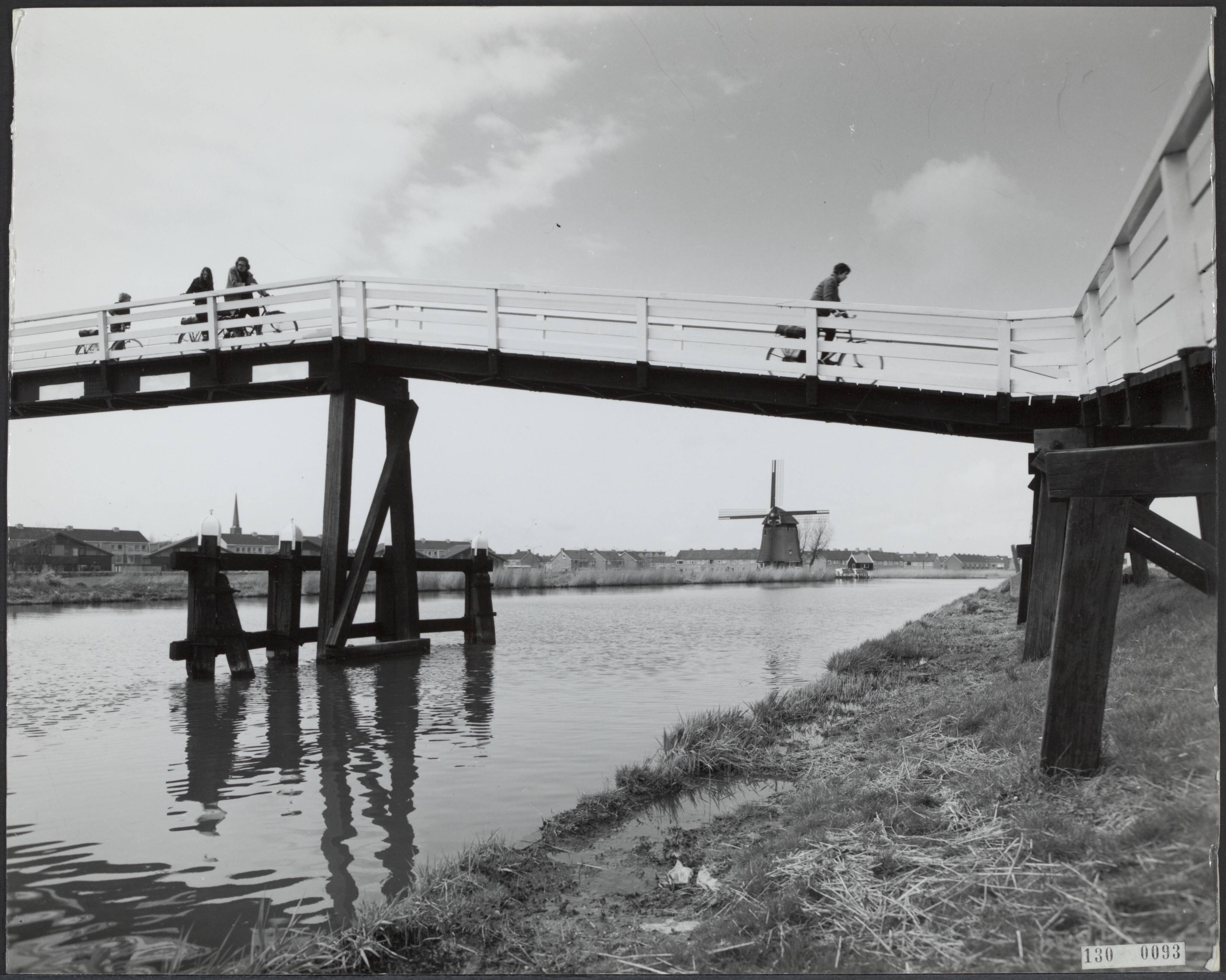 Fotocollectie Rijksvoorlichtingsdienst Eigen — Brug over het kanaal Alkmaar-Kolhorn te Oudorp (N.H.) [op de achtergrond zichtbaar strijkmolen Geestmerambacht (Ambachtsmolen)] — Foto: Publicam / Hartemink, Piet. Licentie: Set B: Rechtenvrij / Publiek Domein. Bron: Nationaal Archief. http://hdl.handle.net/10648/af49d740-d0b4-102d-bcf8-003048976d84
