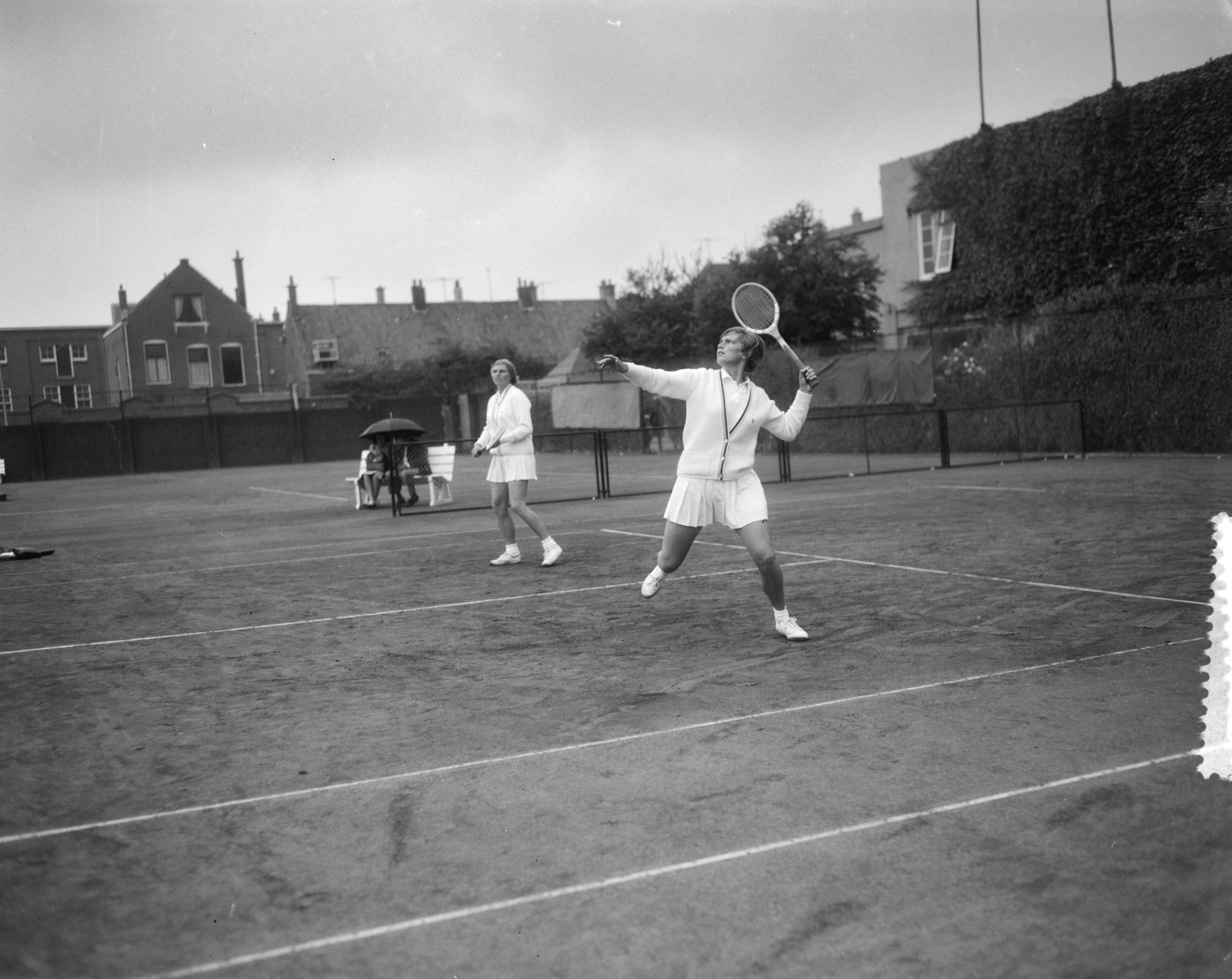 Fotocollectie Anefo — Nederlandse tenniskampioenschappen Metsbanen. Damesdubbel — Foto: Bilsen, Joop van / Anefo. Licentie: Set B: Rechtenvrij / Publiek Domein. Bron: Nationaal Archief. http://hdl.handle.net/10648/aa74f452-d0b4-102d-bcf8-003048976d84
