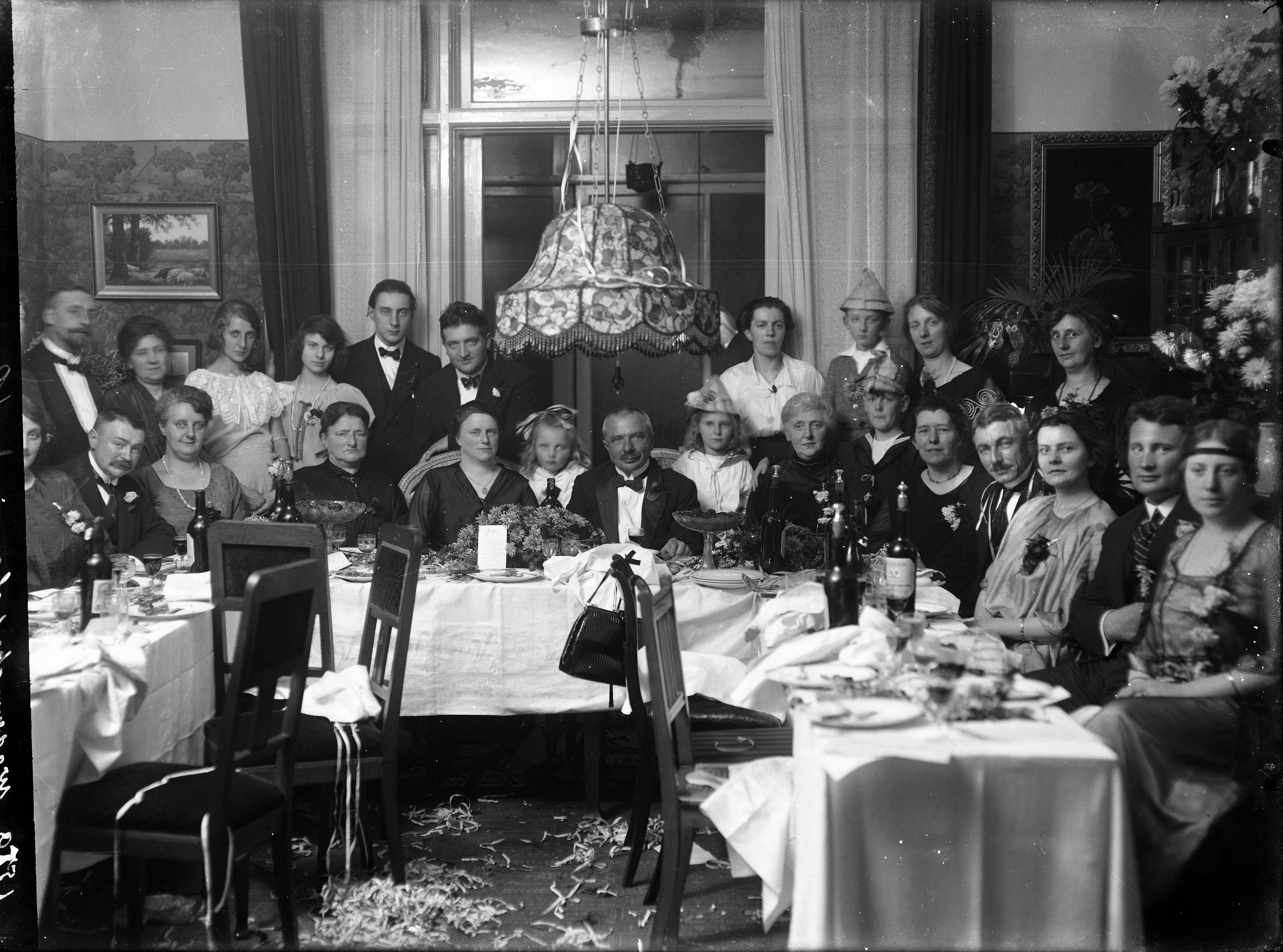 Berg, van den (BERG 050) — Feesten. Opname van een familie aan een feesttafel, ter ere van een jubileumjaar van de ouders, met de kinderen, kleinkinderen, zonen, dochter, partners en andere familieleden eromheen. Nederland. 1918-1930. 1579 Wagenmaker chamois — Foto: Berg, Th.C.J. van den / Spaarnestad Photo (05887). Licentie: Set B: Rechtenvrij / Publiek Domein. Bron: Nationaal Archief. http://hdl.handle.net/10648/35429da7-c778-a382-e063-6df0900a6686
