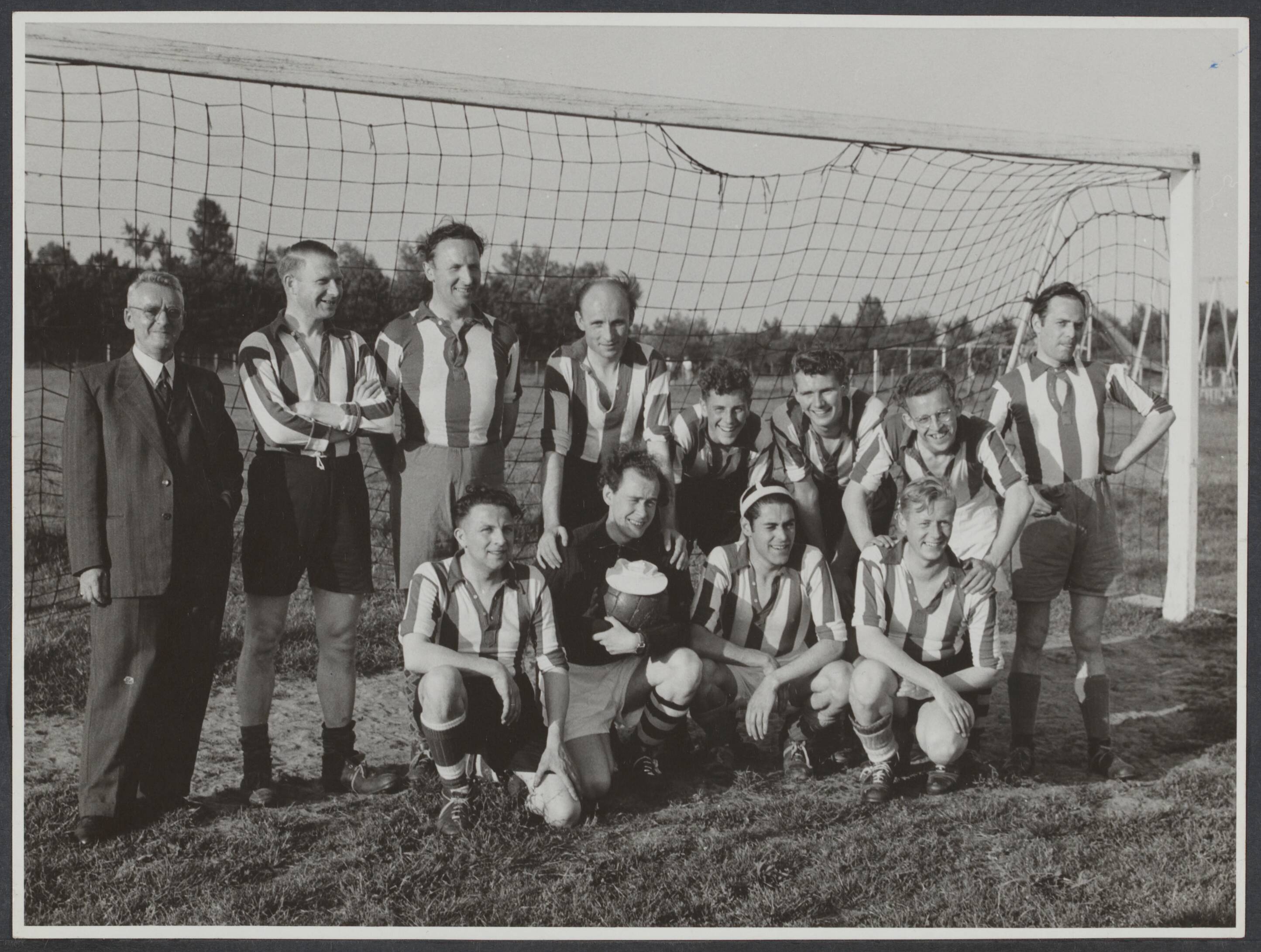 Spaarnestad. Sport en Spel - Nederland — [Serie bedrijfsvoetbal Spaarnestad, diverse jaren] Elftal "Retouche" [voetbalelftal poseert in doel] — Foto: Fotograaf Onbekend / Spaarnestad. Licentie: Set B: Rechtenvrij / Publiek Domein. Bron: Nationaal Archief. http://hdl.handle.net/10648/49a5c056-5839-ffd1-94b2-2a7080064d12
