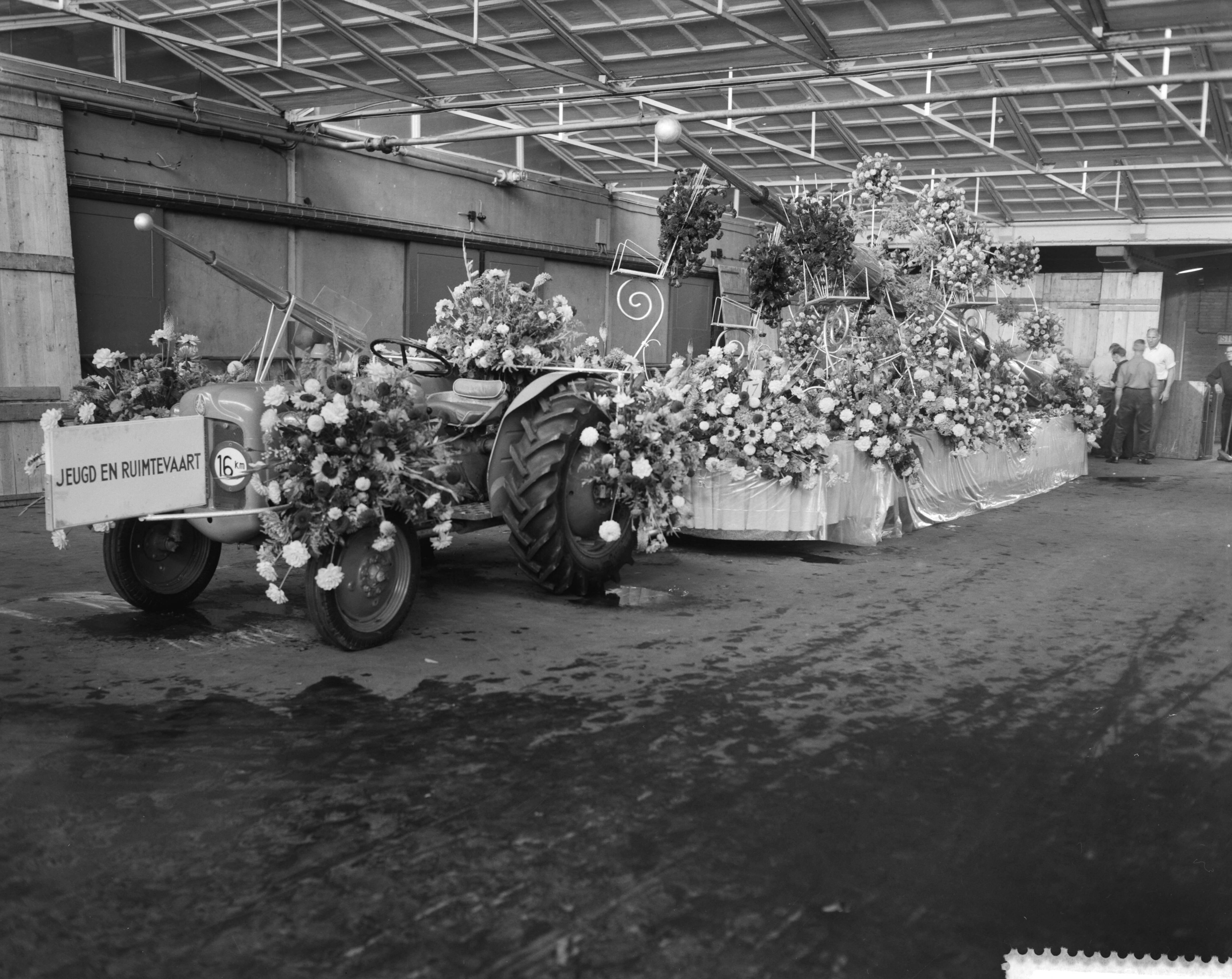 Fotocollectie Anefo — Praalwagens worden opgesierd in de Aalsmeerder veilinghallen voor het bloemencorso — Foto: Bilsen, Joop van / Anefo. Licentie: Set B: Rechtenvrij / Publiek Domein. Bron: Nationaal Archief. http://hdl.handle.net/10648/a9b84424-d0b4-102d-bcf8-003048976d84