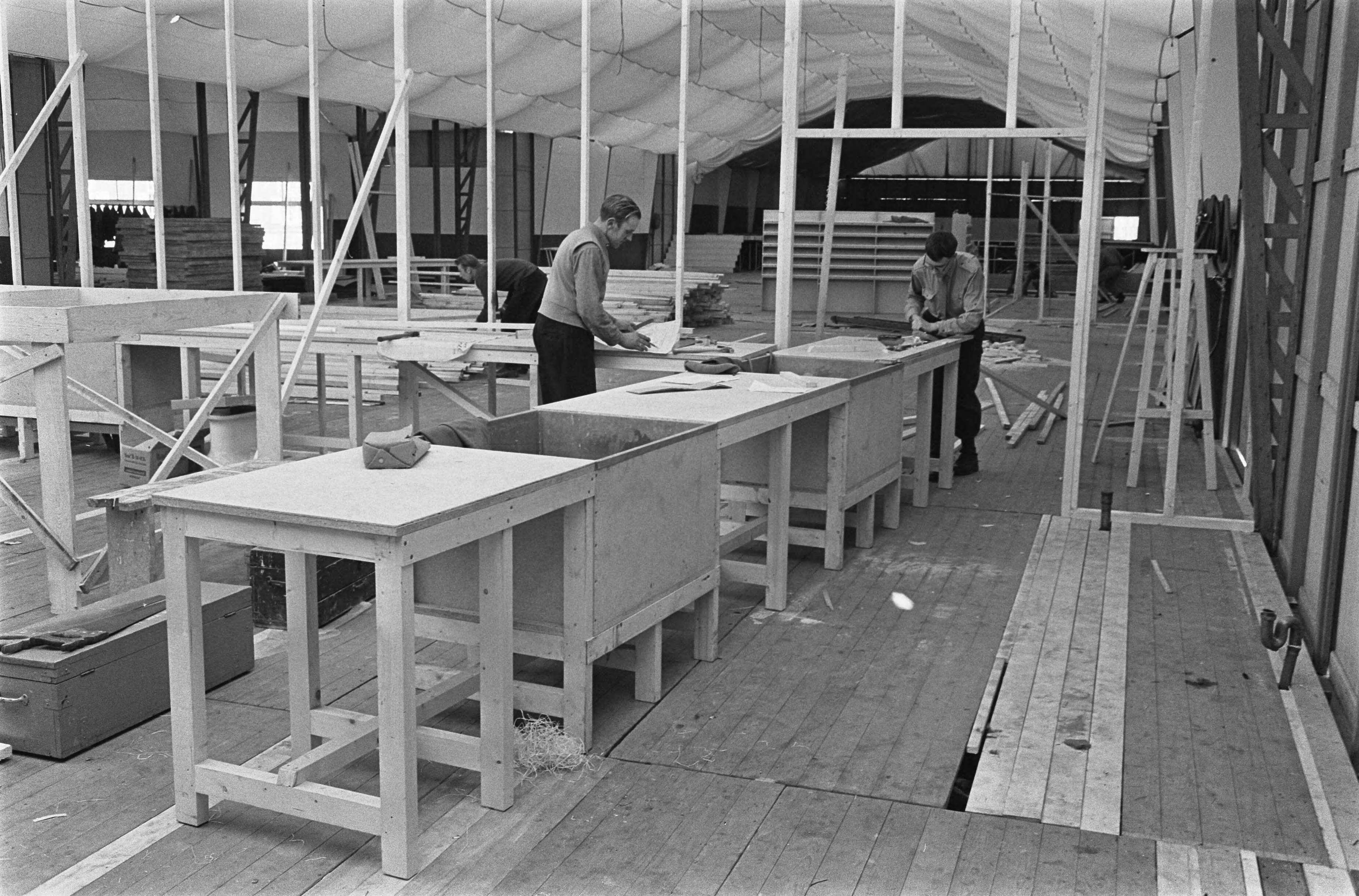 Fotocollectie Anefo — In de Prinses Juliana Kazerne te Den Haag is men bezig met de kazerne gereed te maken voor de grote NATO-conferentie, overzicht grote ruimte in paviljoen perscentrum — Foto: Pot, Harry / Anefo. Licentie: Set B: Rechtenvrij / Publiek Domein. Bron: Nationaal Archief. http://hdl.handle.net/10648/aa63643a-d0b4-102d-bcf8-003048976d84