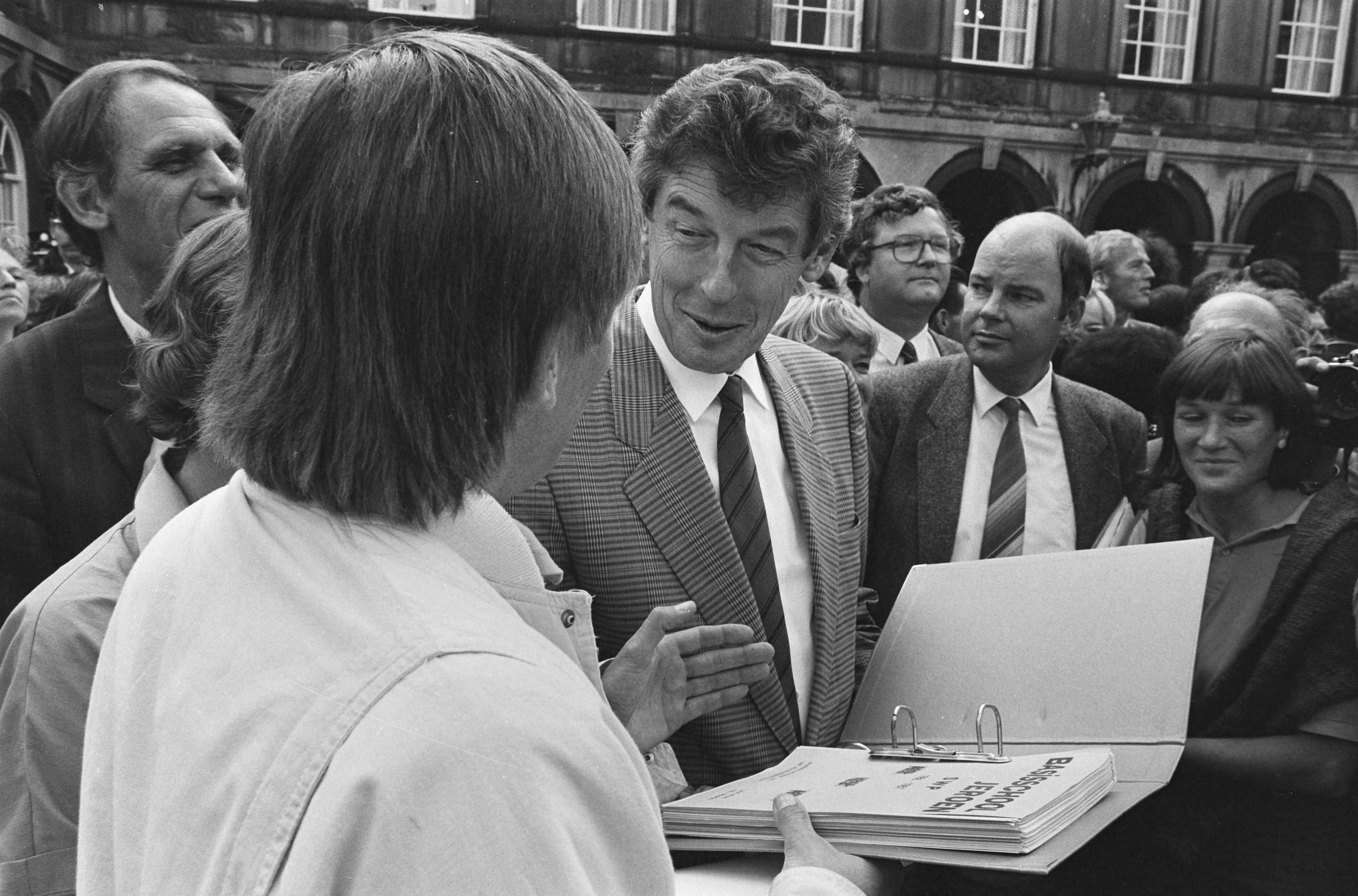 Fotocollectie Anefo — Demonstratie tegen onderwijsbezuinigingen van minister Deetman , op Binnenhof Den Haag ; schoolhoofd overhandigt oppositieleider Wim Kok een — Foto: Gerrits, Roland / Anefo. Licentie: Set B: Rechtenvrij / Publiek Domein. Bron: Nationaal Archief. http://hdl.handle.net/10648/ad57cdf2-d0b4-102d-bcf8-003048976d84