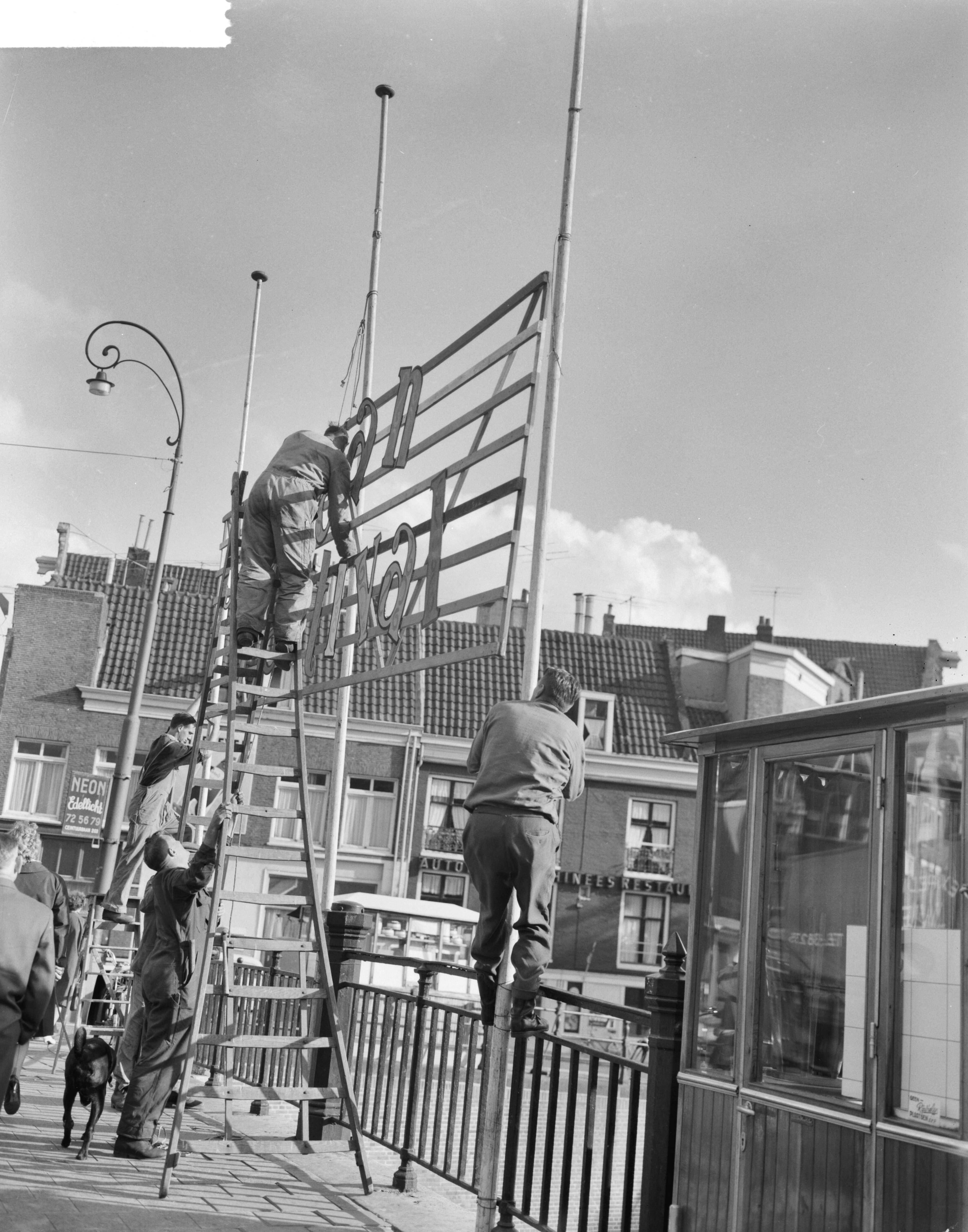 Fotocollectie Anefo — Jordaanfestival in Amsterdam, op de Rozengracht wordt versiering aangebracht — Foto: Gelderen, Hugo van / Anefo. Licentie: Set B: Rechtenvrij / Publiek Domein. Bron: Nationaal Archief. http://hdl.handle.net/10648/aa16c2b0-d0b4-102d-bcf8-003048976d84