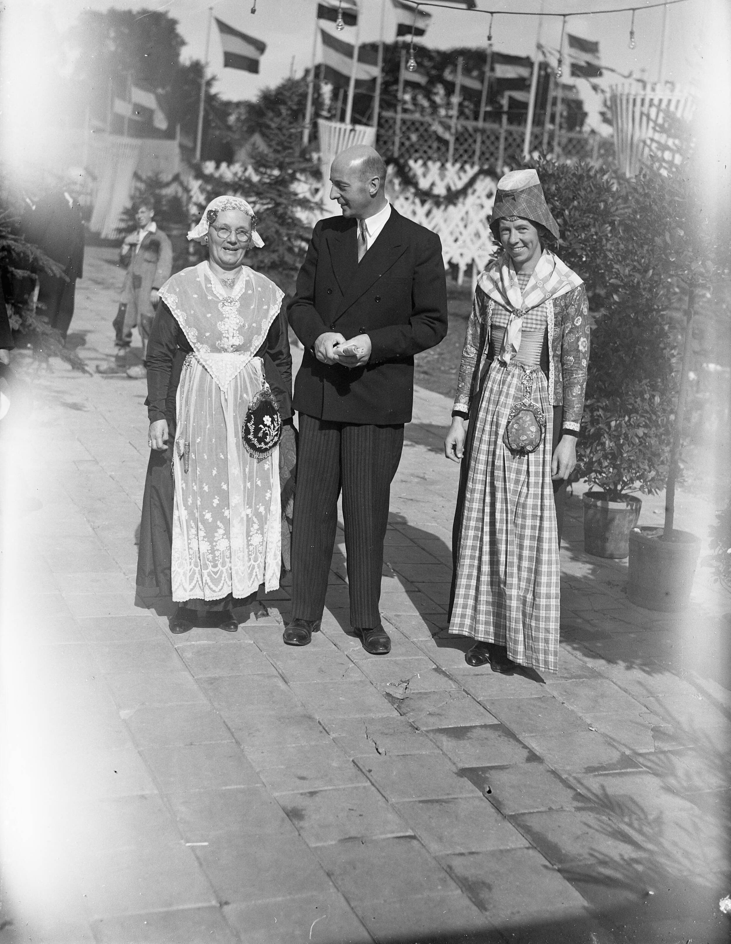 Fotocollectie Anefo — Opening Landbouwtentoonstelling te Leeuwarden [minister Mansholt tussen twee vrouwen in Friese klederdracht] — Foto: Noske, J.D. / Anefo. Licentie: Set B: Rechtenvrij / Publiek Domein. Bron: Nationaal Archief. http://hdl.handle.net/10648/a8ad4ff2-d0b4-102d-bcf8-003048976d84