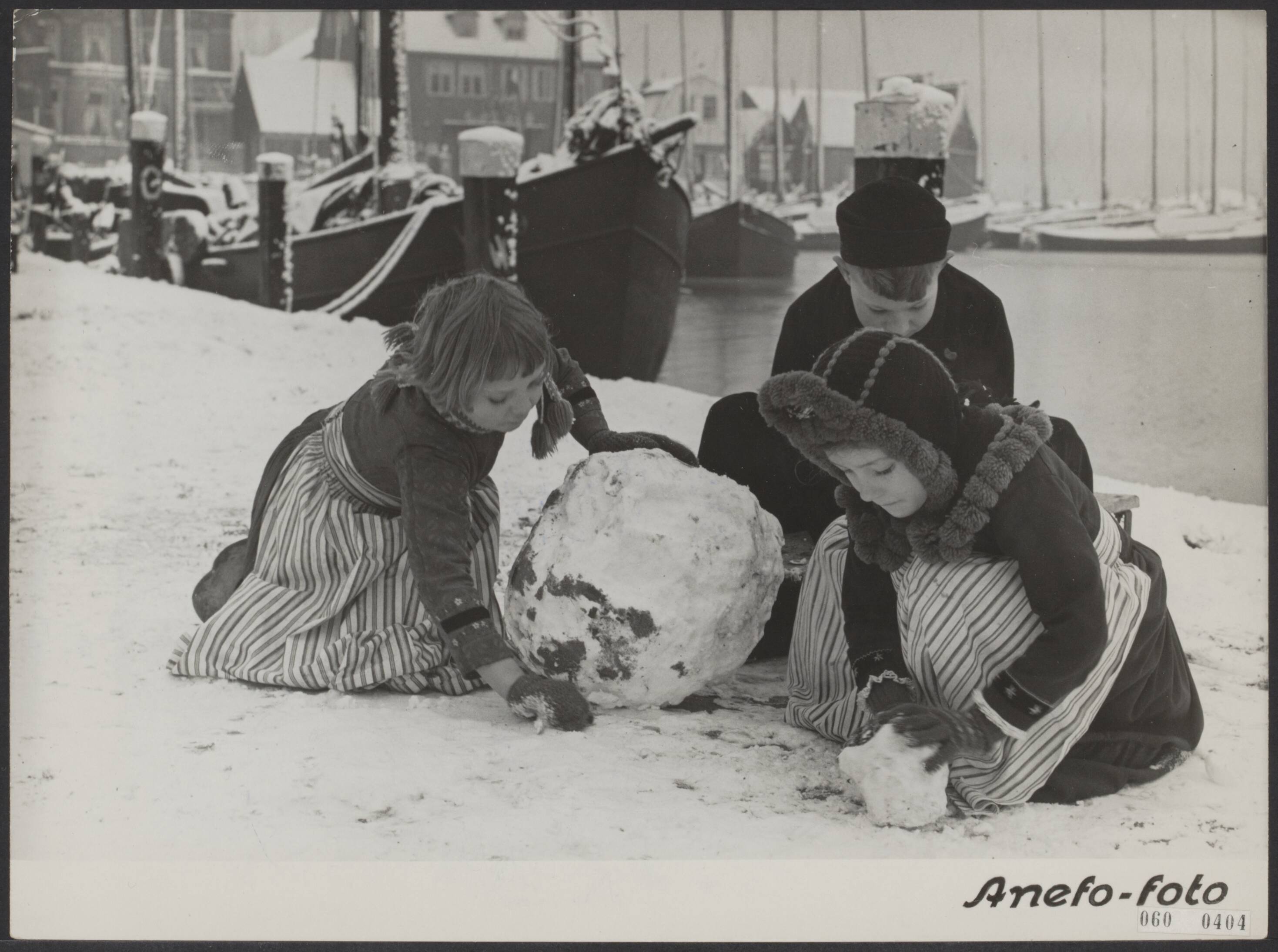 Fotocollectie Elsevier Binnenland — Holland in de sneeuw. De Volendammer jeugd rolt grote sneeuwballen — Foto: Fotograaf Onbekend / Anefo. Licentie: Set B: Rechtenvrij / Publiek Domein. Bron: Nationaal Archief. http://hdl.handle.net/10648/ae0da118-d0b4-102d-bcf8-003048976d84