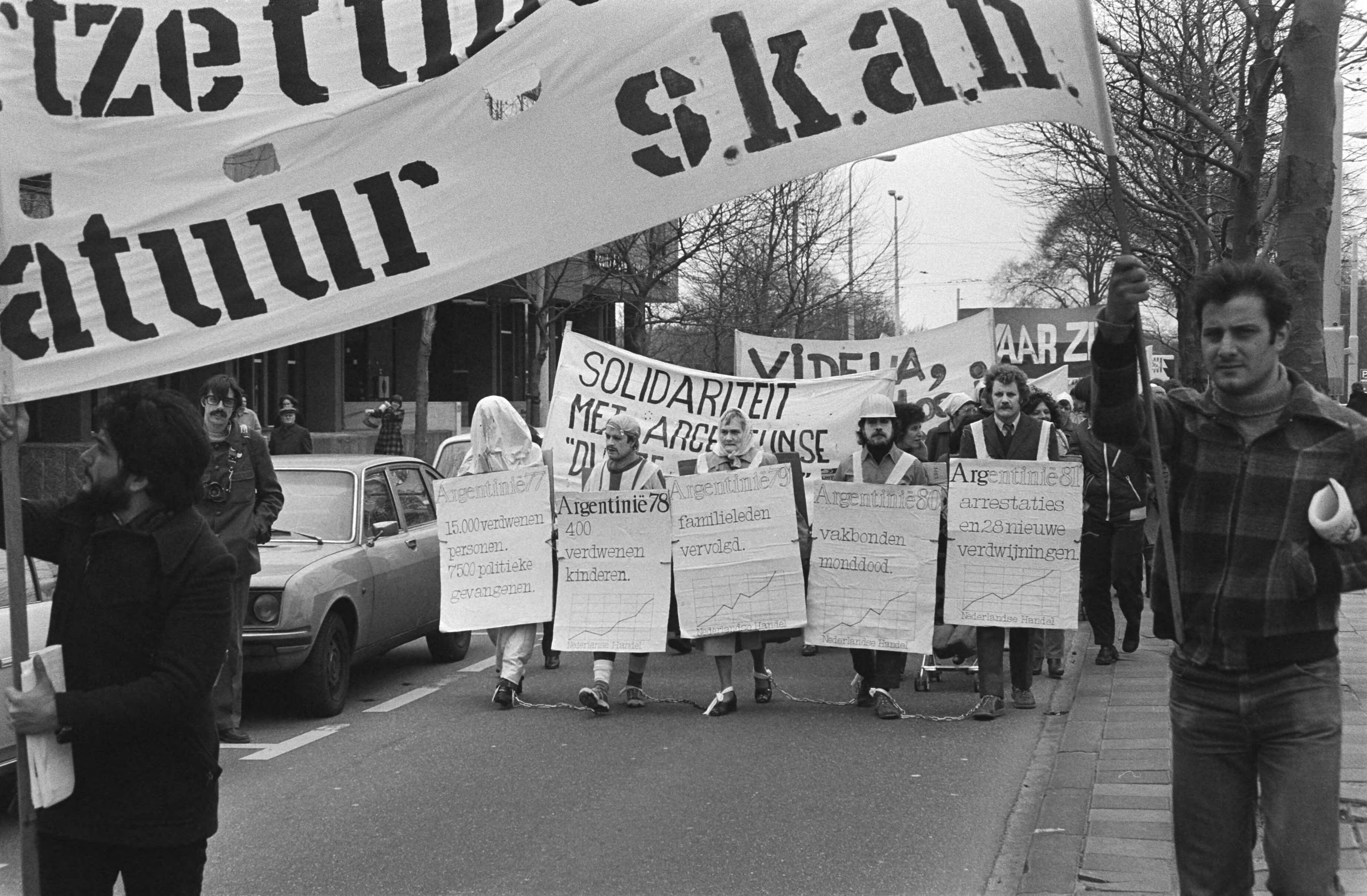 Fotocollectie Anefo — Demonstratie in Den Haag tegen dictatuur in Argentinie, demonstranten onderweg — Foto: Dijk, Hans van / Anefo. Licentie: Set B: Rechtenvrij / Publiek Domein. Bron: Nationaal Archief. http://hdl.handle.net/10648/acf7db68-d0b4-102d-bcf8-003048976d84