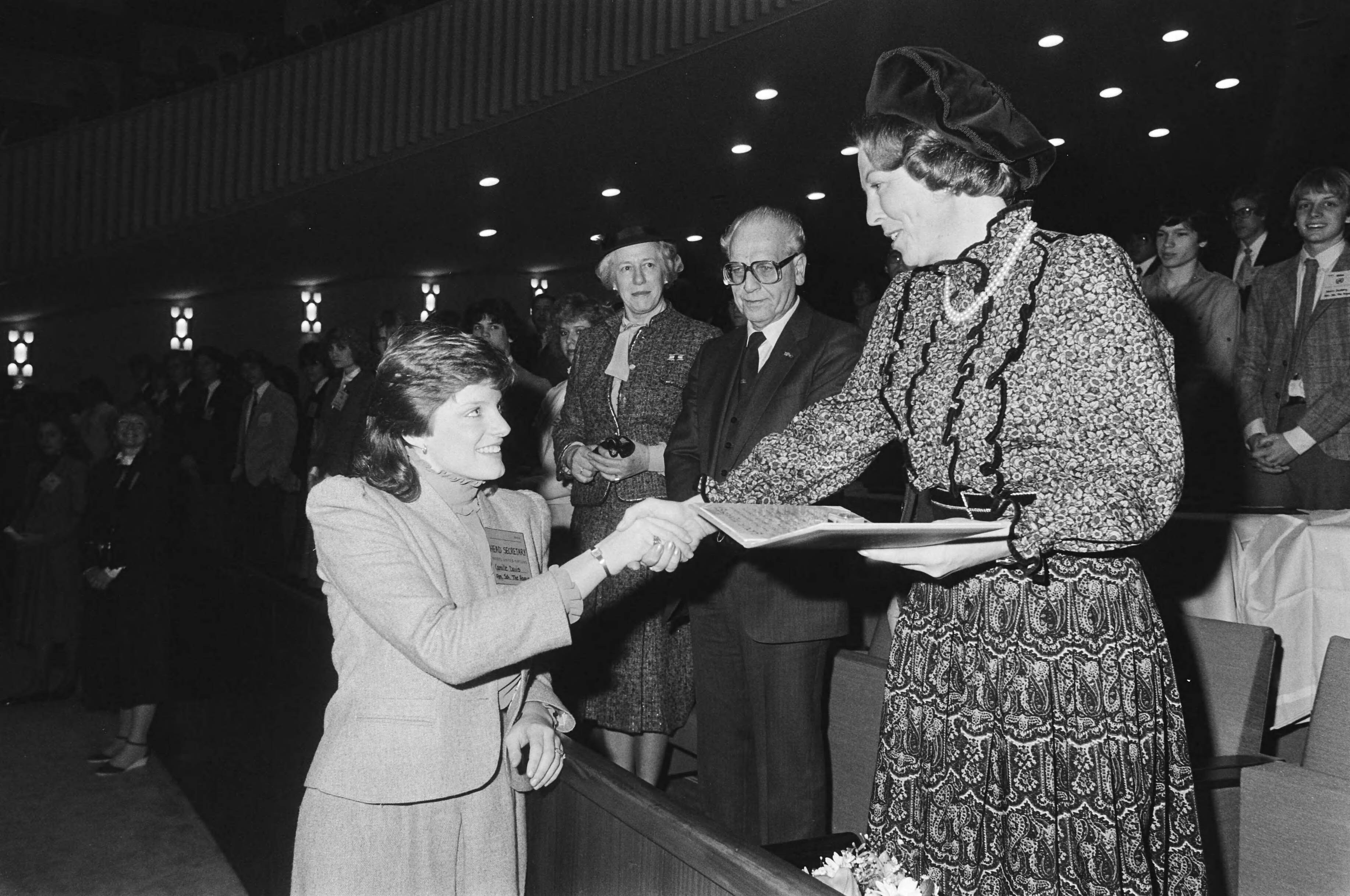 Koningin Beatrix opent het Verenigde Naties Jeugdcongres in Den Haag — Koningin Beatrix krijgt een geschenk — Foto: Bogaerts, Rob / Anefo. Licentie: Set B: Rechtenvrij / Publiek Domein. Bron: Nationaal Archief. http://hdl.handle.net/10648/ad24d294-d0b4-102d-bcf8-003048976d84