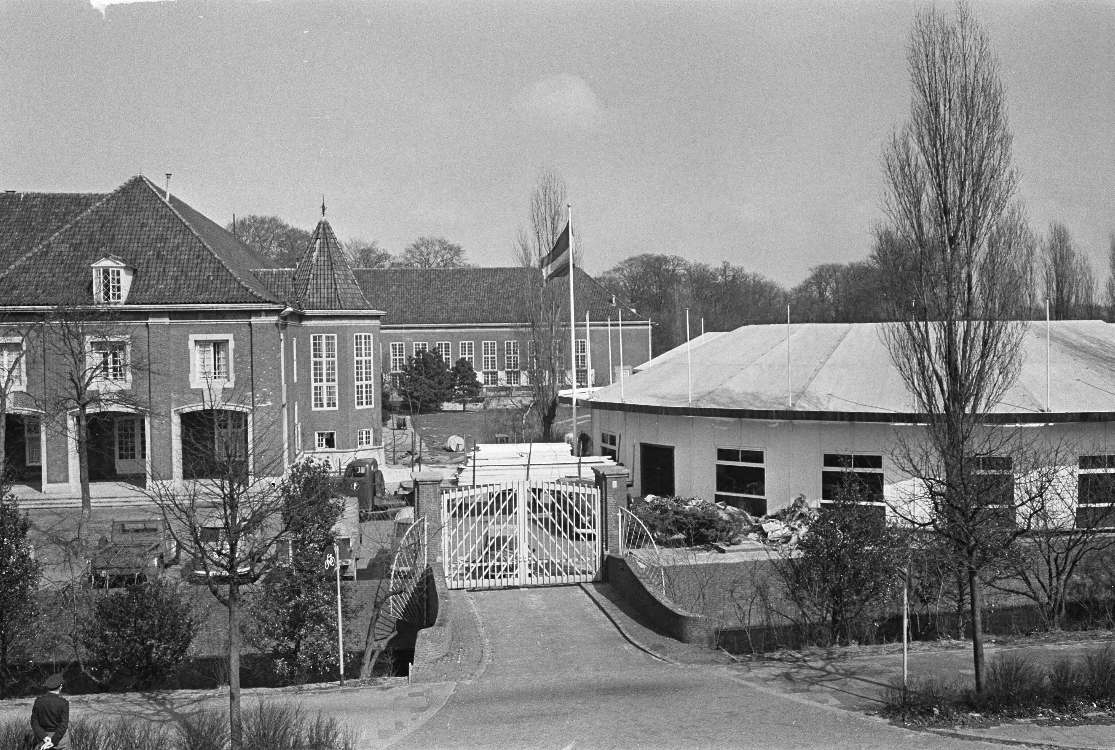 Fotocollectie Anefo — In de Prinses Juliana Kazerne te Den Haag is men bezig met de kazerne gereed te maken voor de grote NATO-conferentie, overzicht met rechts het paviljoen — Foto: Pot, Harry / Anefo. Licentie: Set B: Rechtenvrij / Publiek Domein. Bron: Nationaal Archief. http://hdl.handle.net/10648/aa636692-d0b4-102d-bcf8-003048976d84