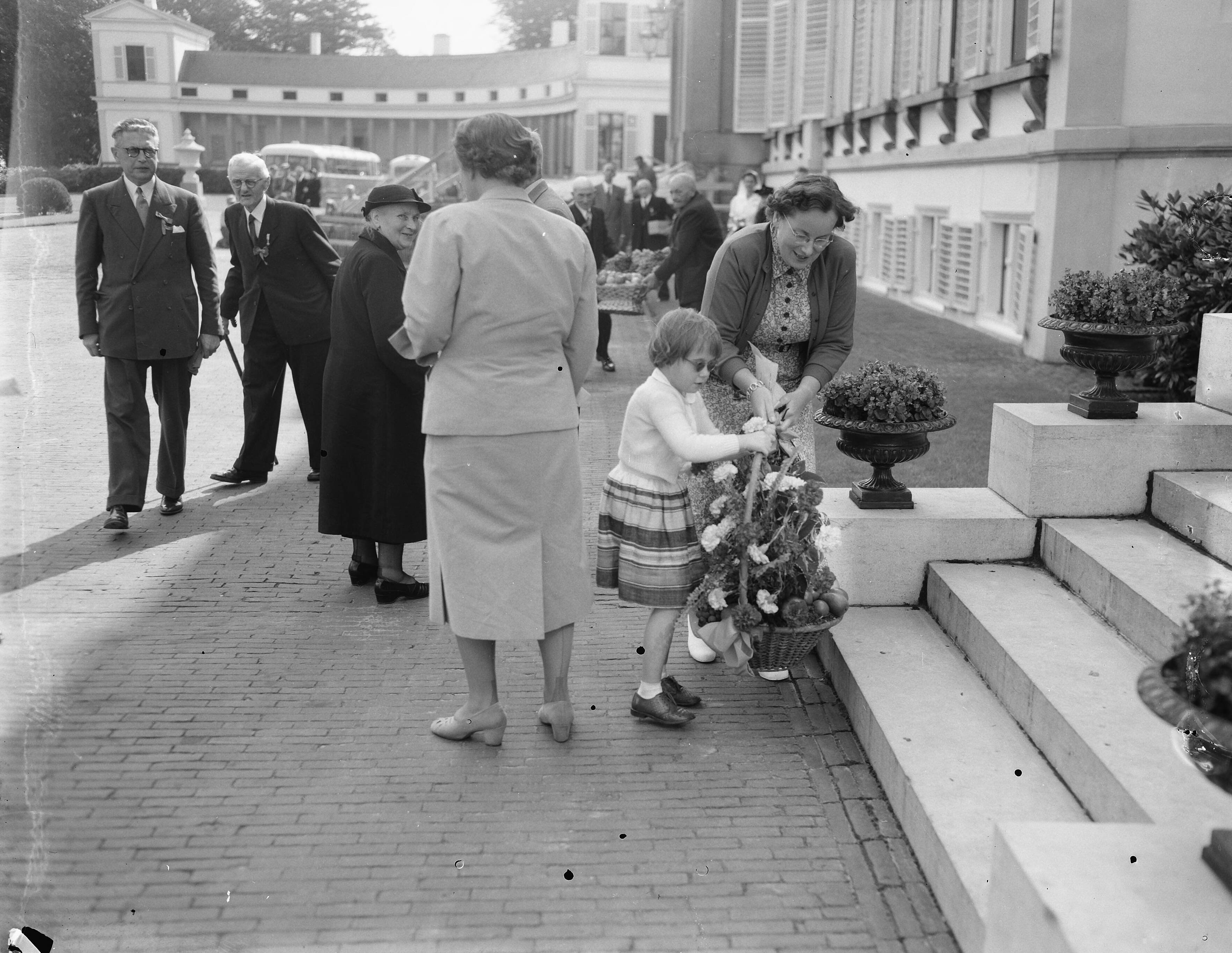 Fotocollectie Anefo — Koningin Juliana ontvangt delegaties Nederlandse bejaarden op paleis Soestdijk. De 89-jarige mevr. de wed. J. van Eymeren— Zijdemans uit Rotterdam en haar geleidster, zuster G. M. van Blooys, werden begroet door koningin Juliana en prinses Marijke. — Foto: Noske, J.D. / Anefo. Licentie: Set B: Rechtenvrij / Publiek Domein. Bron: Nationaal Archief. http://hdl.handle.net/10648/a92985b8-d0b4-102d-bcf8-003048976d84