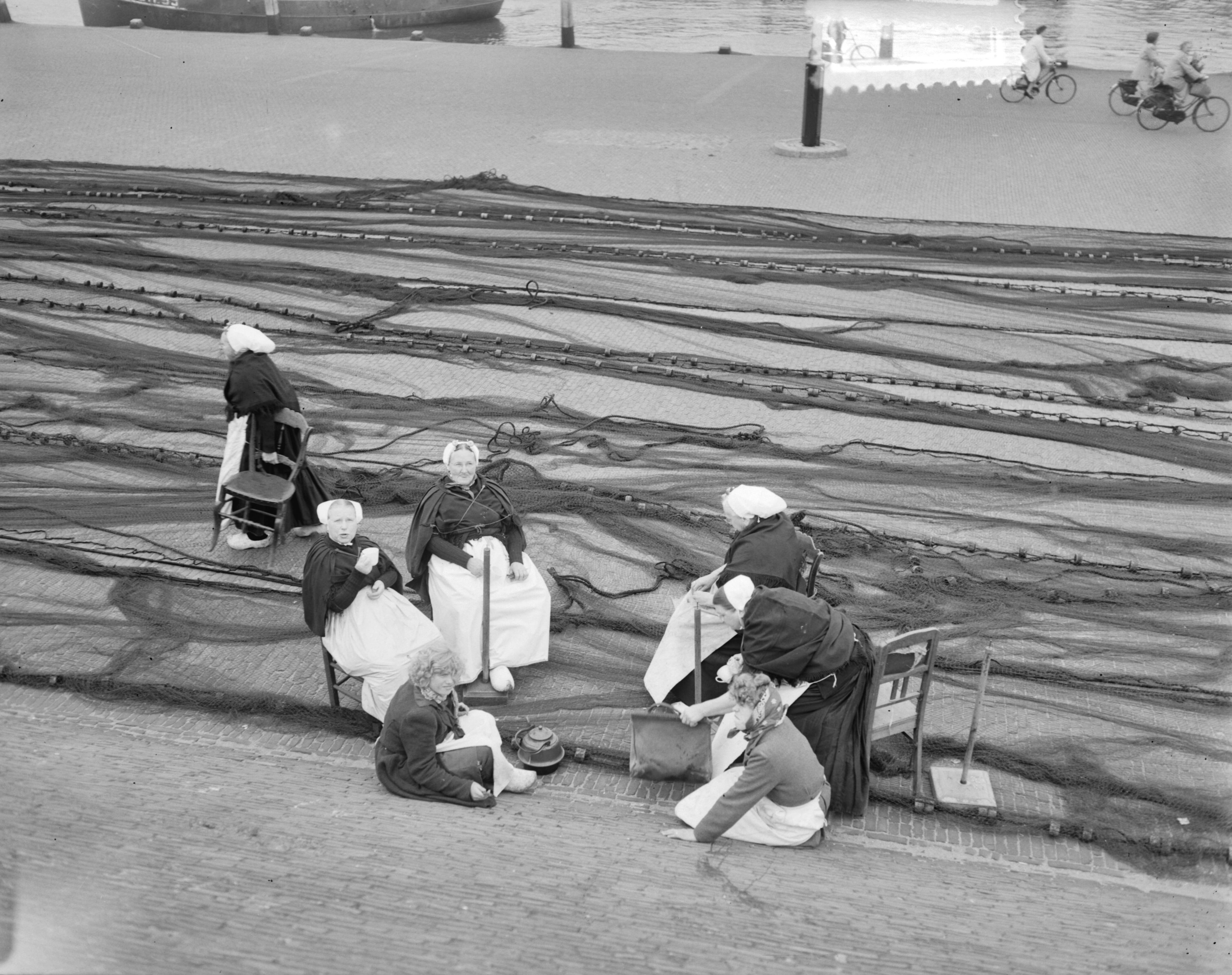 Fotocollectie Anefo — Scheveningse vrouwen aan het netten boeten — Foto: Duinen, G.W. van / Anefo. Licentie: Set B: Rechtenvrij / Publiek Domein. Bron: Nationaal Archief. http://hdl.handle.net/10648/a90d76de-d0b4-102d-bcf8-003048976d84