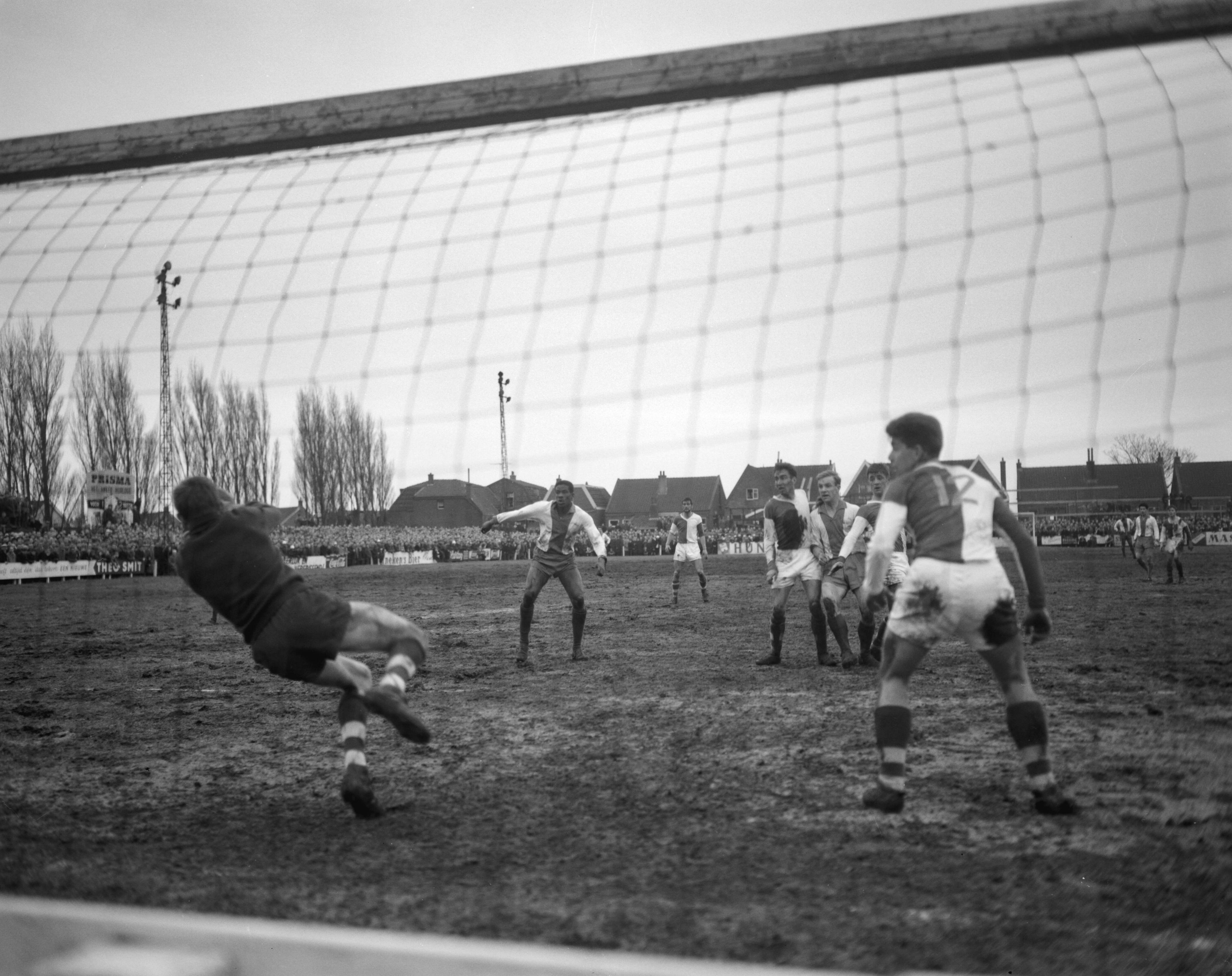 Fotocollectie Anefo — Voetbal. ZFC tegen Elinkwijk 1-2. Spelmoment voor het doel van ZFC. Links Michel Kruin (Elinkwijk), tussen twee ZFC-verdedigers Jan de Jongh. ZFC keeper De Ruyter duikt — Foto: Bilsen, Joop van / Anefo. Licentie: Set B: Rechtenvrij / Publiek Domein. Bron: Nationaal Archief. http://hdl.handle.net/10648/a9f74b56-d0b4-102d-bcf8-003048976d84