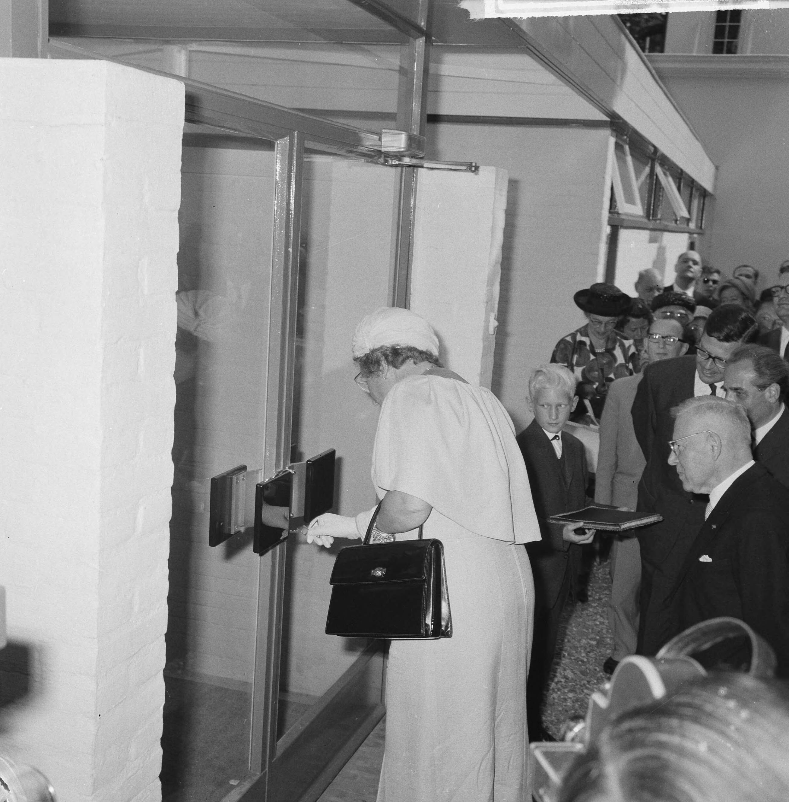 Fotocollectie Anefo — Koningin Juliana opent de Hemofiliekliniek in Huizen, door het openen van de deuren — Foto: Nijs, Jac. de / Anefo. Licentie: Set B: Rechtenvrij / Publiek Domein. Bron: Nationaal Archief. http://hdl.handle.net/10648/aa6eb466-d0b4-102d-bcf8-003048976d84