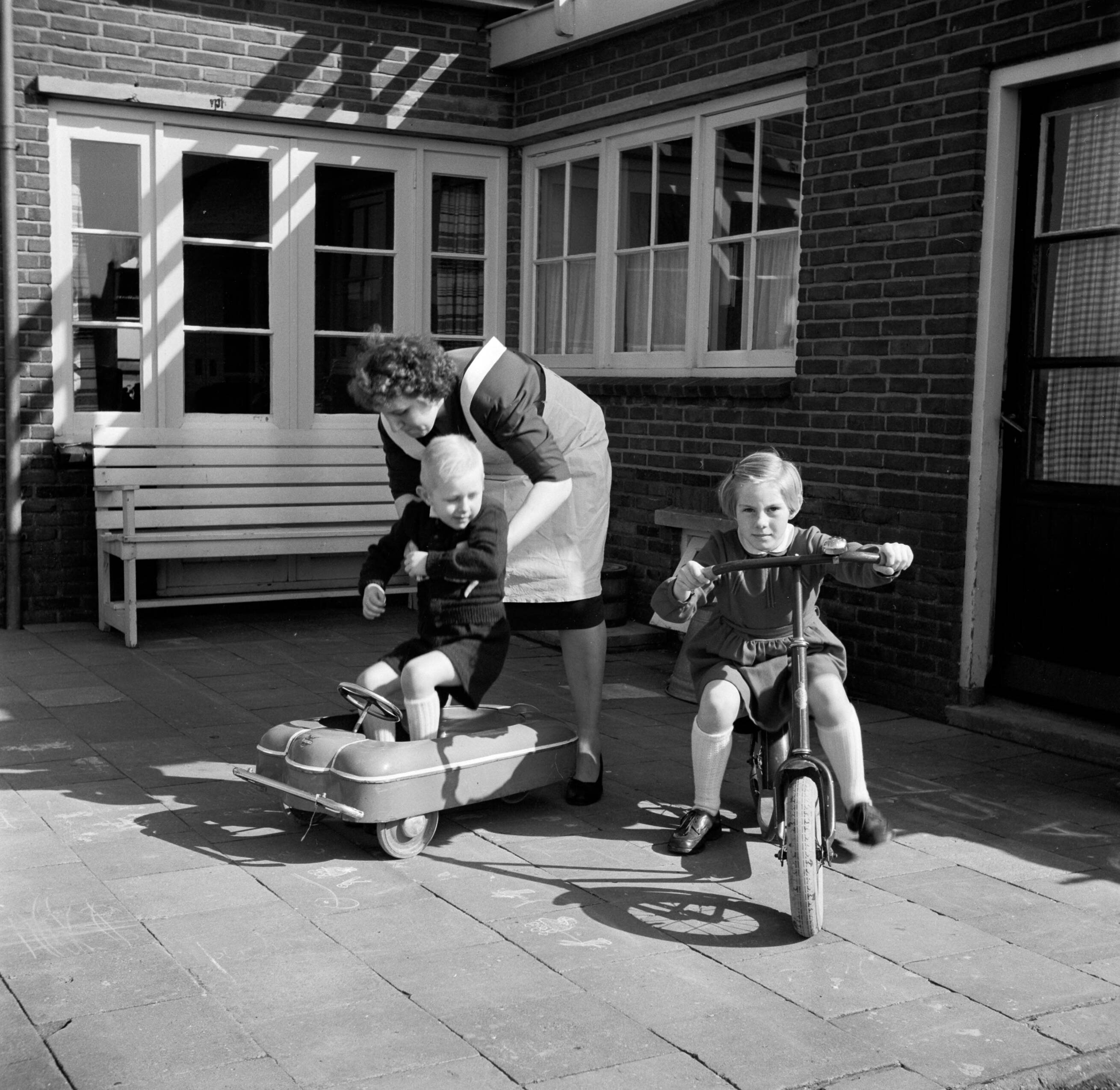Fotocollectie Van de Poll — De echtgenote van Gerard de Jong met vierjarige zoon Gerrie en achtjarige dochter Marietje op een plaatsje bij hun huis — Foto: Poll, Willem van de. Licentie: Set B: Rechtenvrij / Publiek Domein. Bron: Nationaal Archief. http://hdl.handle.net/10648/aecccb88-d0b4-102d-bcf8-003048976d84