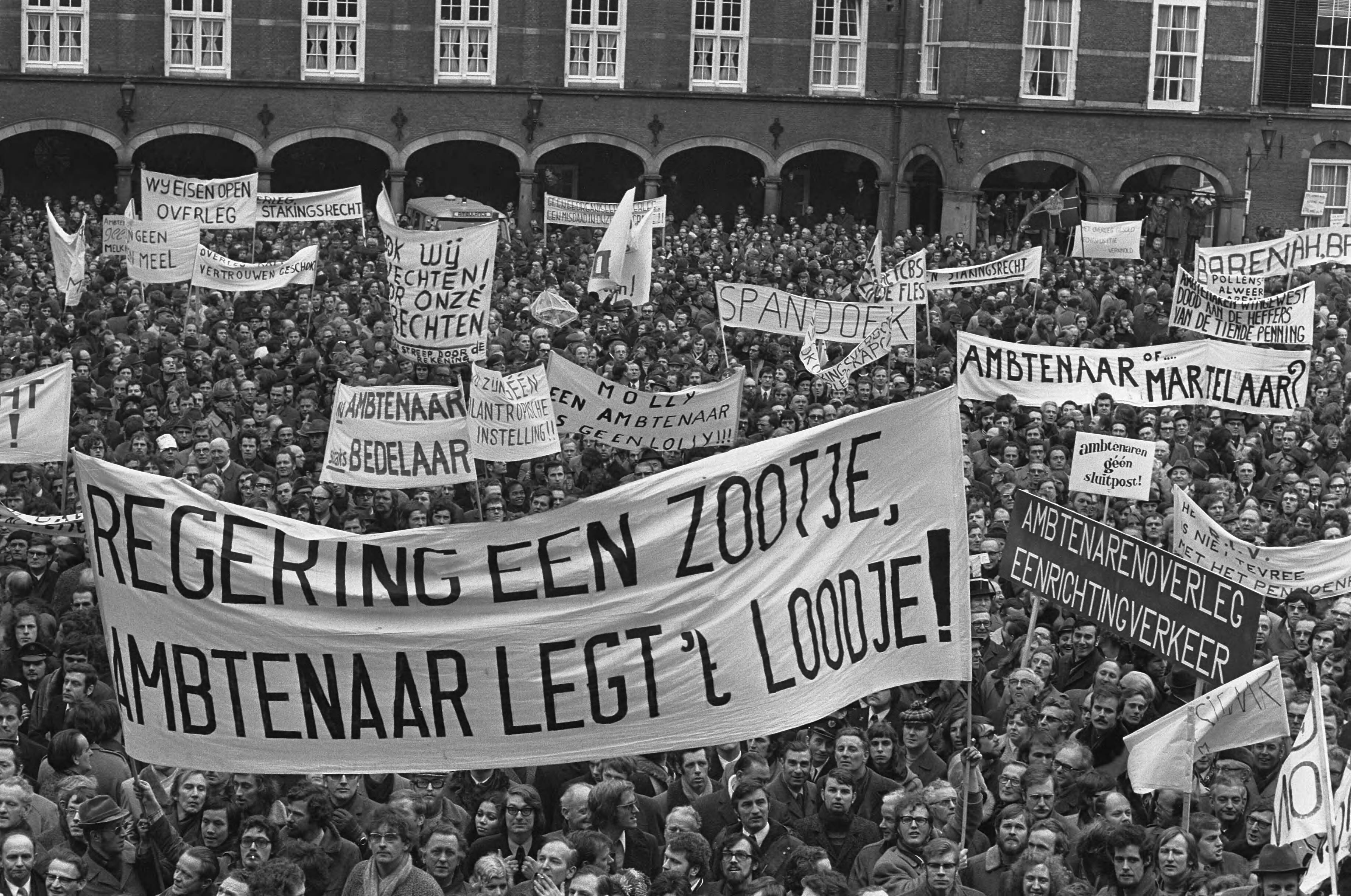 Fotocollectie Anefo — Ambtenaren (meer dan 40.000) demonstreren in Den Haag , de demonstranten op Binnenhof, veel spandoeken — Foto: Peters, Hans / Anefo. Licentie: Set B: Rechtenvrij / Publiek Domein. Bron: Nationaal Archief. http://hdl.handle.net/10648/ac244ff0-d0b4-102d-bcf8-003048976d84