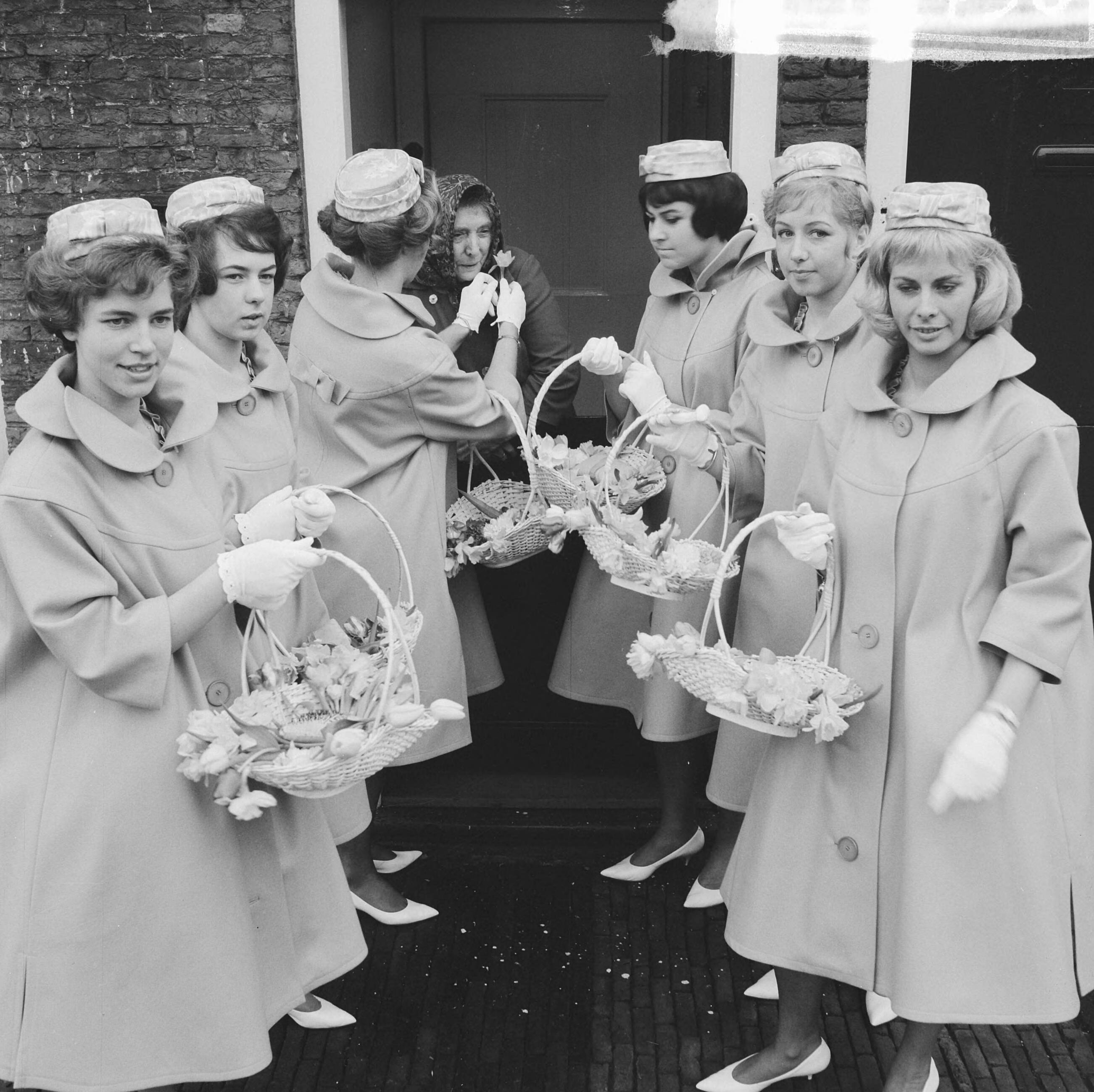 Fotocollectie Anefo — Haarlemse bloemenmeisjes in nieuw pakje, hun nieuwe Boussac katoenen jurkjes. Enkele meisjes op het Proveniershofje te Haarlem — Foto: Nijs, Jac. de / Anefo. Licentie: Set B: Rechtenvrij / Publiek Domein. Bron: Nationaal Archief. http://hdl.handle.net/10648/aa2e6ec4-d0b4-102d-bcf8-003048976d84