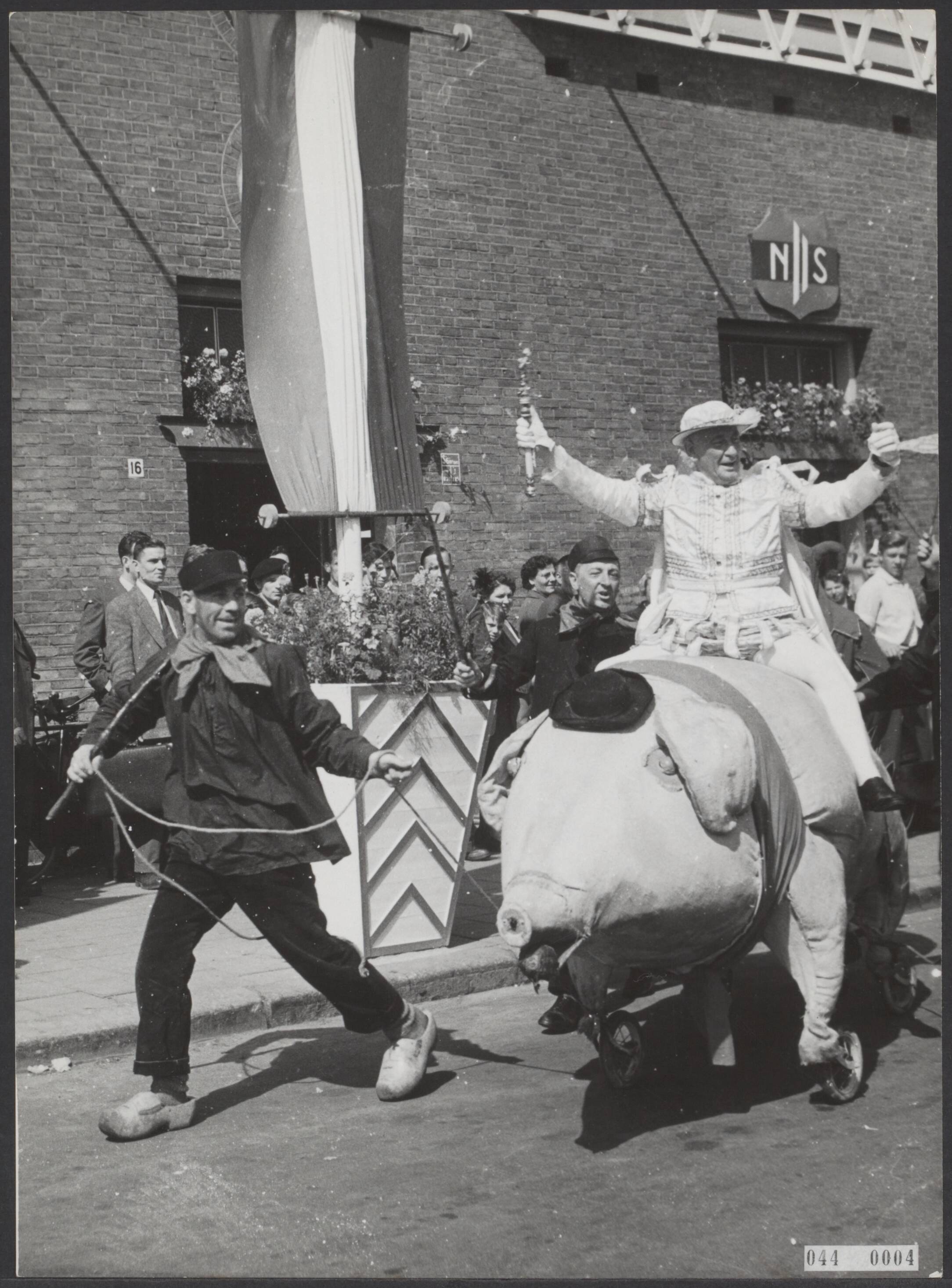 Fotocollectie Elsevier Binnenland — In Breda is de door watersnood uitgestelde carnavalsviering nu pas begonnen. Na zijn aankomst maakte prins Maskerado III op een "vet varken" een ere-ronde op het Stationsplein — Foto: Fotograaf Onbekend / Anefo. Licentie: Set B: Rechtenvrij / Publiek Domein. Bron: Nationaal Archief. http://hdl.handle.net/10648/adfab1a2-d0b4-102d-bcf8-003048976d84