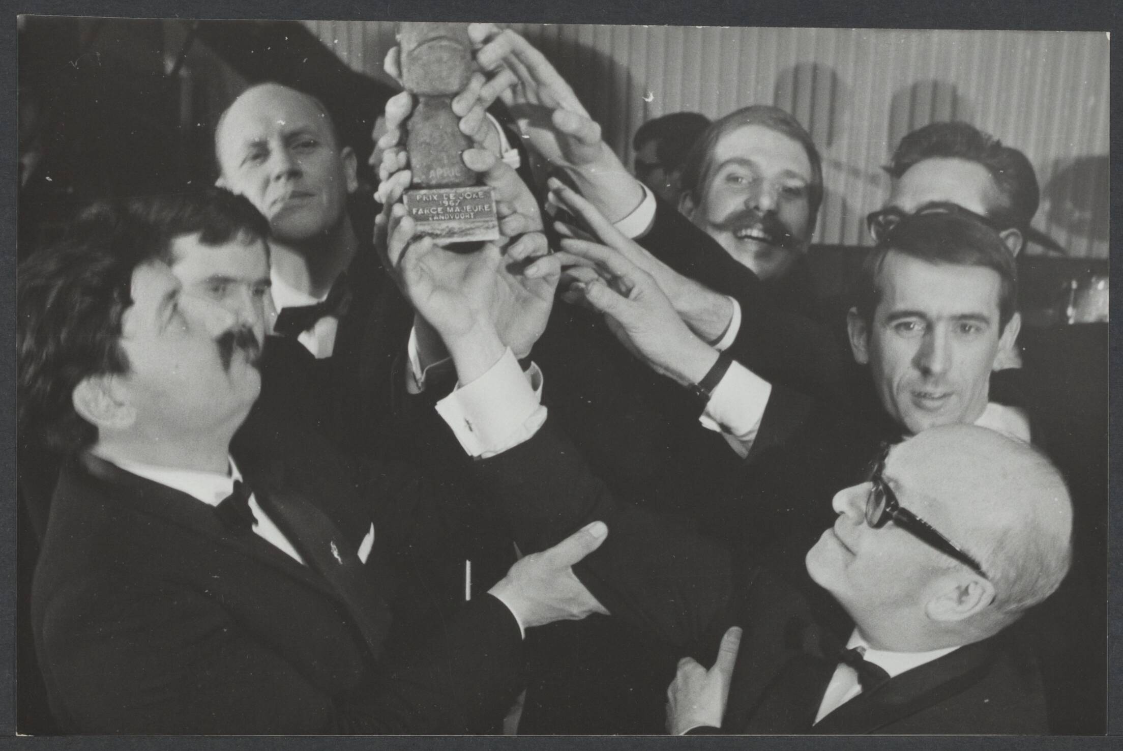 Algemeen, overheidsbemoeiing, coördinatie, commerciele televisie — Prix de Joke voor Farce Majeure. In het hotel Bouwes te Zandvoort werd zaterdagavond de Prix de Joke uitgereikt aan de groep "Farce Majeure", de parodistische, satirische en originele groep TV-mensen voor hun werk. Het beeldje in handen van Fred Benavente (links) en Alexander Pola rechts — Foto: Nijs, Jac. de / Anefo. Licentie: Set B: Rechtenvrij / Publiek Domein. Bron: Nationaal Archief. http://hdl.handle.net/10648/102096e3-8e2f-3ac6-70e3-13887b86ce54