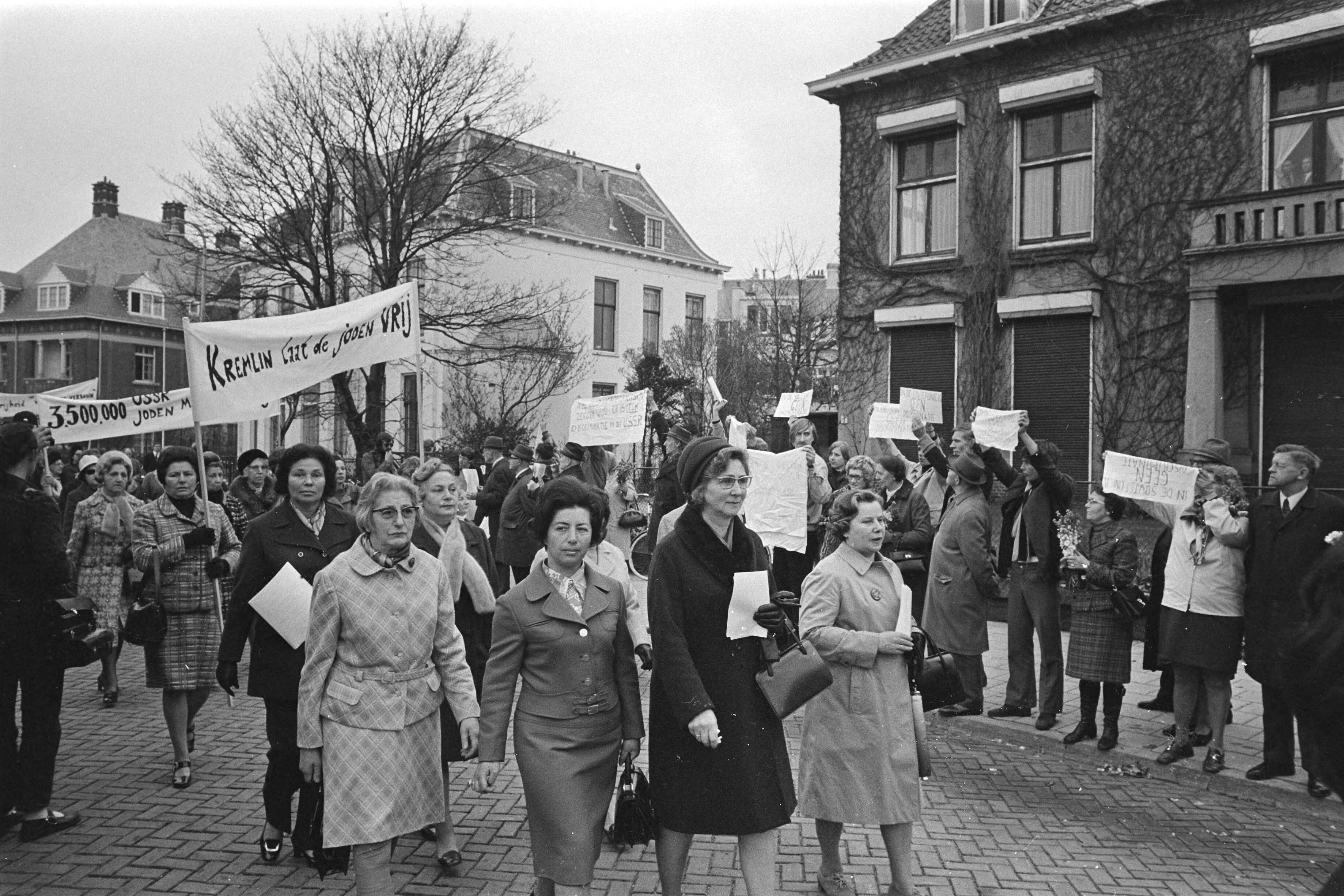 Protest van joodse vrouwenorganisaties bij de Russische ambassade in Den Haag tegen de behandeling van joden in Rusland — Demonstranten met op de achtergrond pro-Russische demonstranten — Foto: Fotograaf Onbekend / Anefo. Licentie: Set B: Rechtenvrij / Publiek Domein. Bron: Nationaal Archief. http://hdl.handle.net/10648/abbbfd1a-d0b4-102d-bcf8-003048976d84