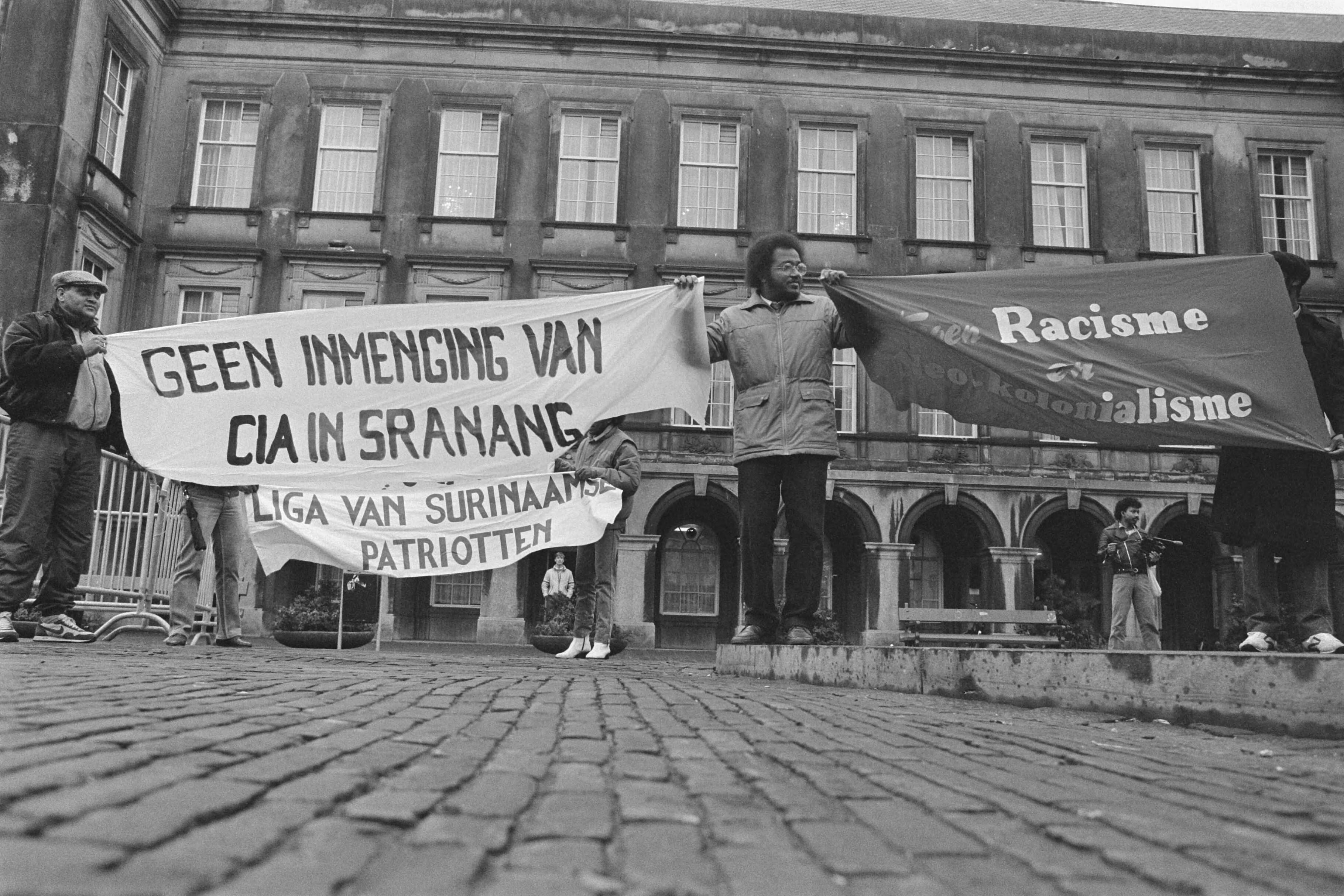 Fotocollectie Anefo — Demonstratie pro-Bouterse van "Liga van Surinaamse Patriotten" op Binnenhof in Den Haag — Foto: Bogaerts, Rob / Anefo. Licentie: Set B: Rechtenvrij / Publiek Domein. Bron: Nationaal Archief. http://hdl.handle.net/10648/ad5ac52a-d0b4-102d-bcf8-003048976d84