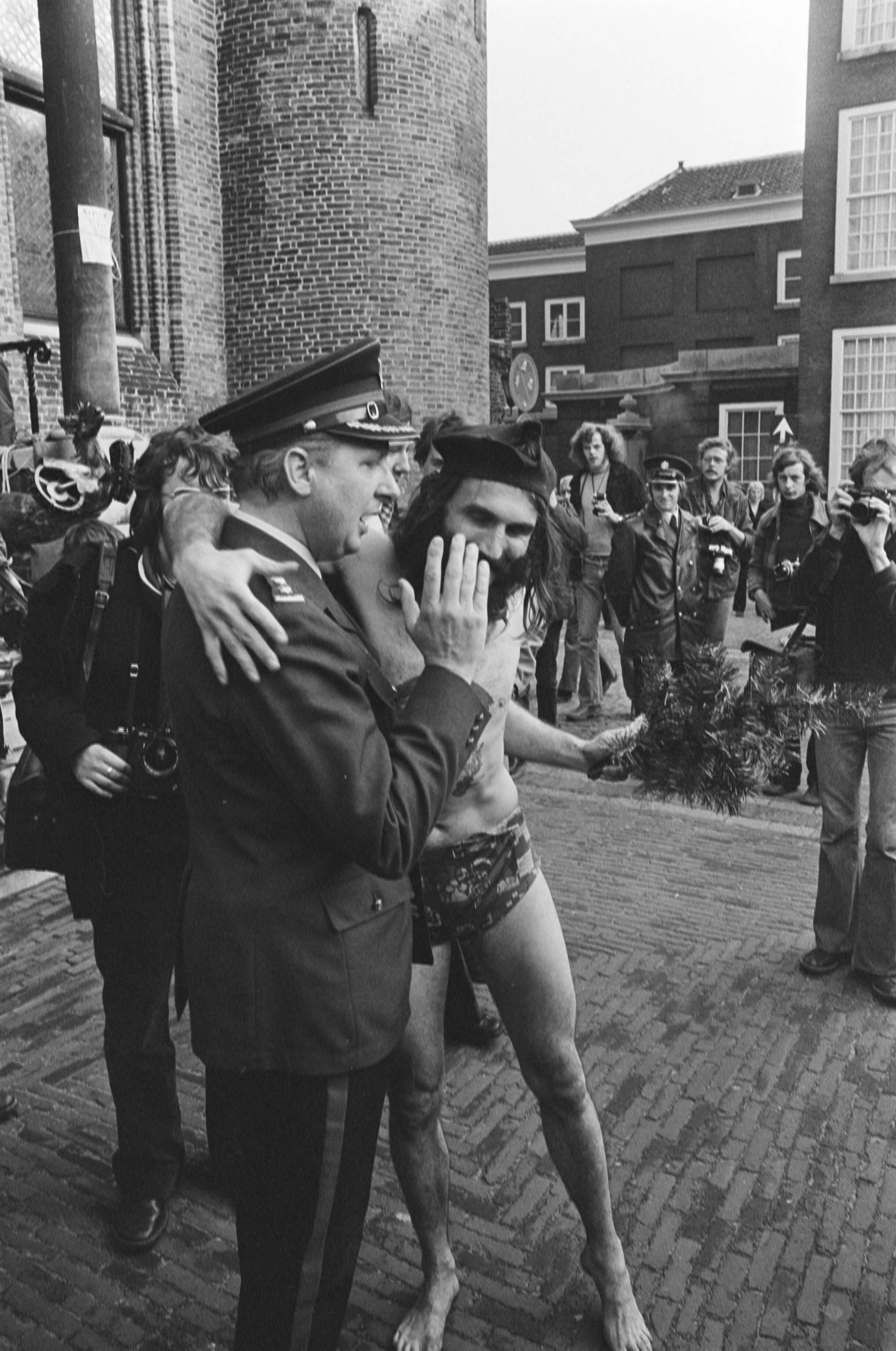 Fotocollectie Anefo — Demonstratie voor hasj-legalisering, Den Haag ; demonstrant in zwembroek omhelst agent — Foto: Croes, Rob C. / Anefo. Licentie: Set B: Rechtenvrij / Publiek Domein. Bron: Nationaal Archief. http://hdl.handle.net/10648/ac75fb52-d0b4-102d-bcf8-003048976d84