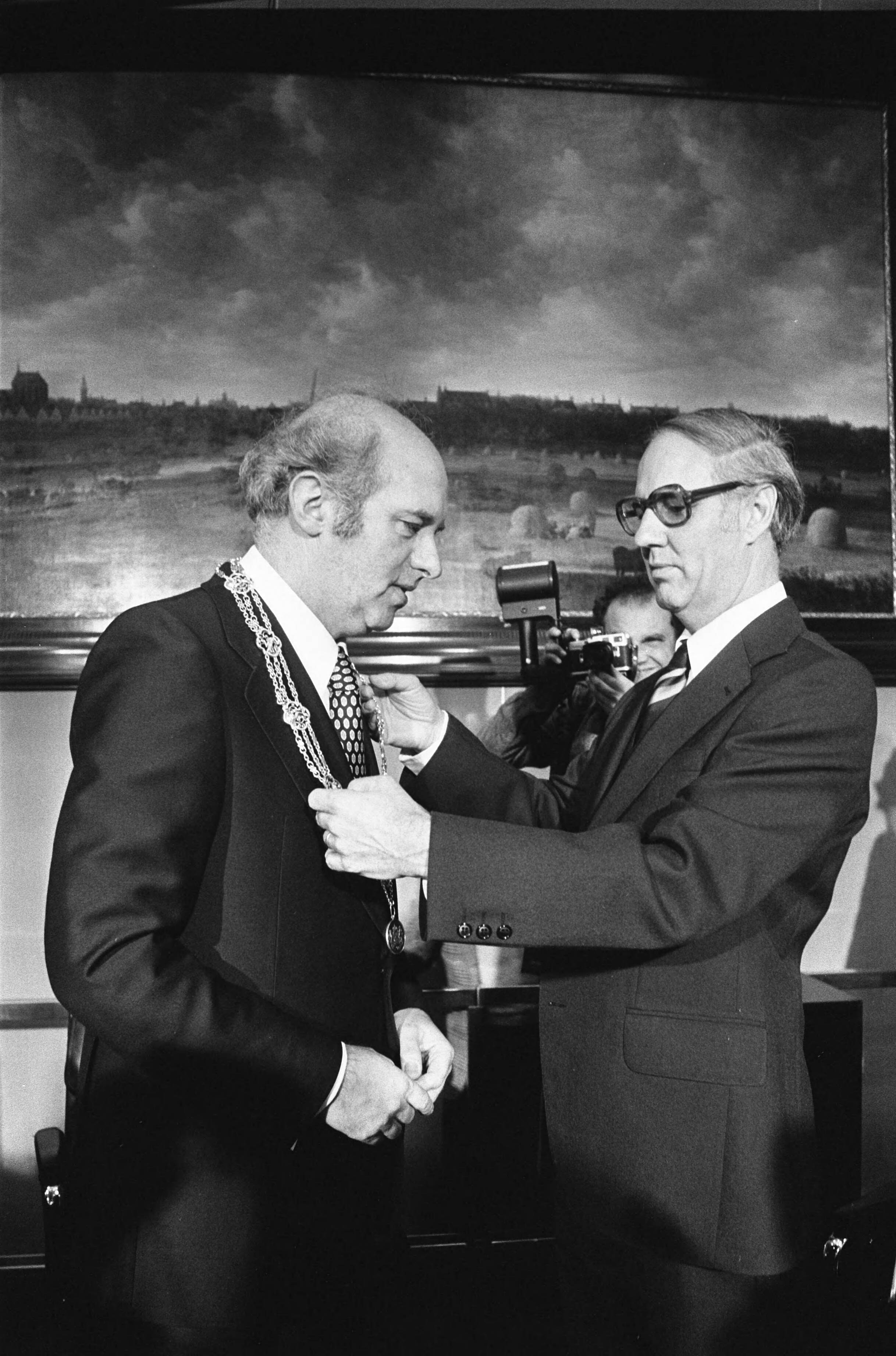 Fotocollectie Anefo — Burgemeester F. G. L. L. Schols van Den Haag geinstalleerd; loco-burgemeester H. Happel (rechts) hangt burgemeester Schols de ambtsketen om / — Foto: Croes, Rob C. / Anefo. Licentie: Set B: Rechtenvrij / Publiek Domein. Bron: Nationaal Archief. http://hdl.handle.net/10648/ac74446a-d0b4-102d-bcf8-003048976d84
