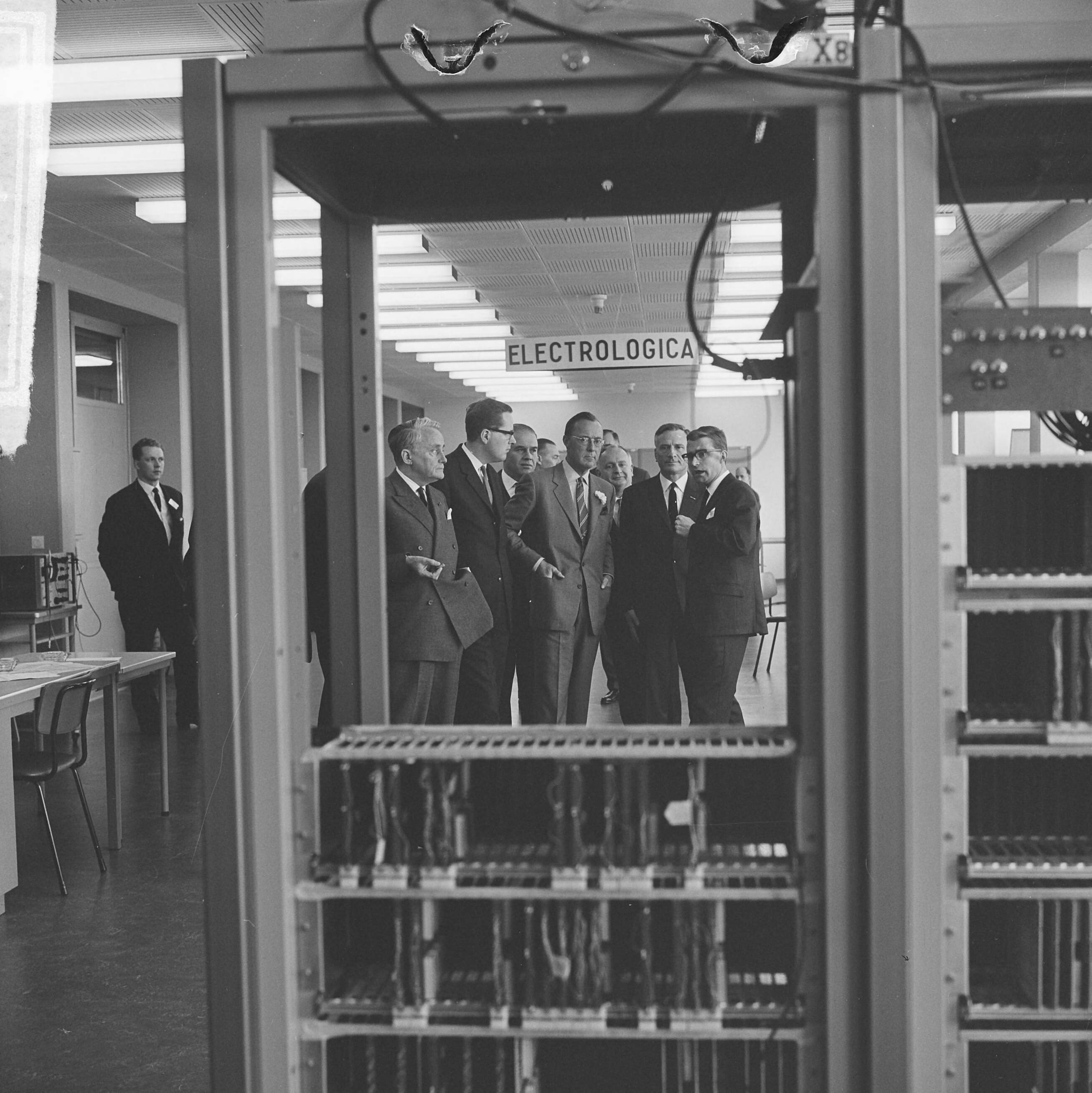 Fotocollectie Anefo — Prins Bernhard opende computerfabriek N.V. Electrologica te Rijswijk, de prins tijdens rondgang. — Foto: Koch, Eric / Anefo. Licentie: Set B: Rechtenvrij / Publiek Domein. Bron: Nationaal Archief. http://hdl.handle.net/10648/aa84da98-d0b4-102d-bcf8-003048976d84