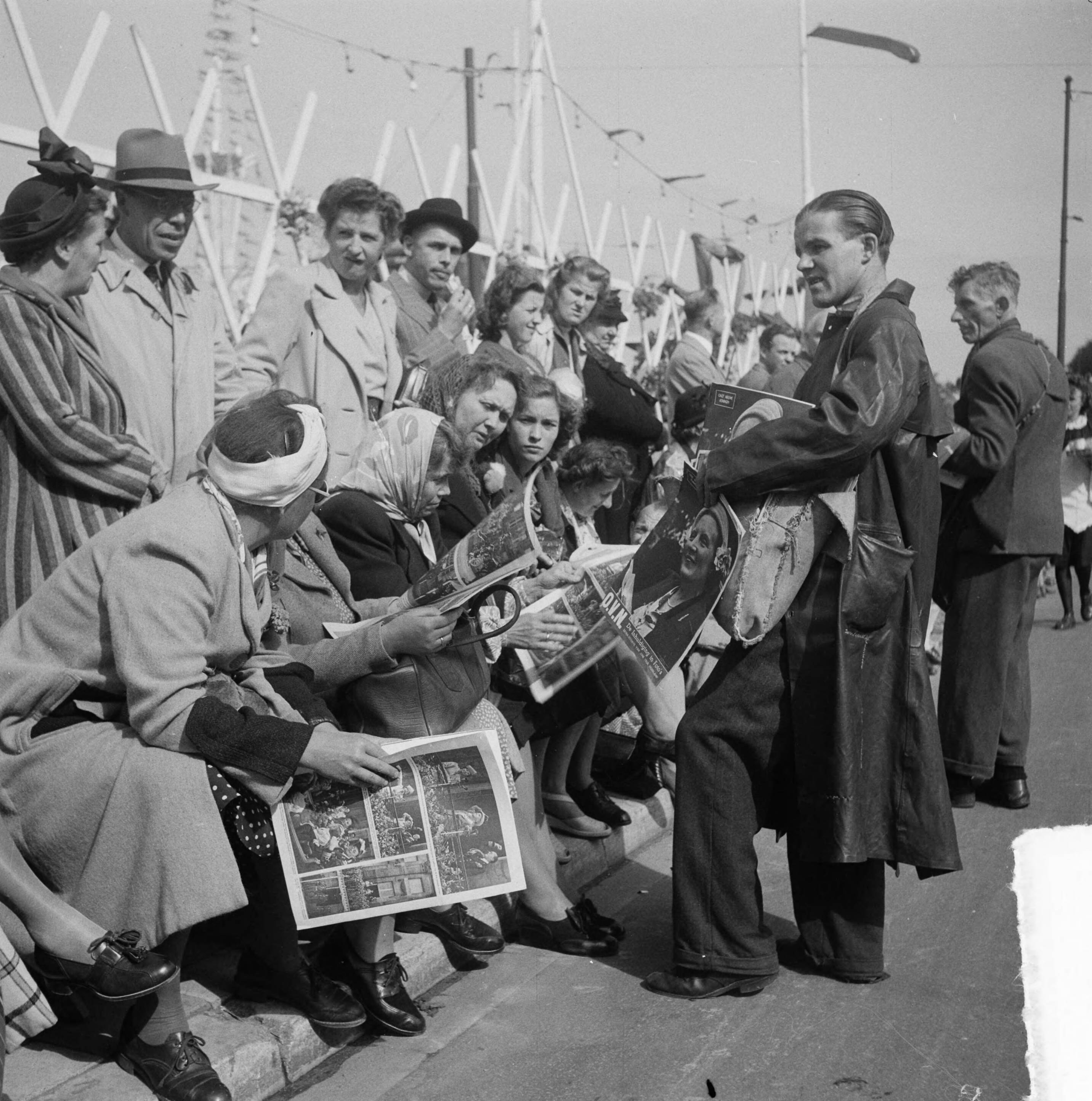Intocht van koningin Juliana in Den Haag (1948) — Intocht Koningin Juliana in Den Haag. Verkopers van het tijdschrift O.V.N. gaan langs het publiek — Foto: Steenkamp, B.J.J. (Ben) / Anefo. Licentie: Set B: Rechtenvrij / Publiek Domein. Bron: Nationaal Archief. http://hdl.handle.net/10648/a8bd43b2-d0b4-102d-bcf8-003048976d84