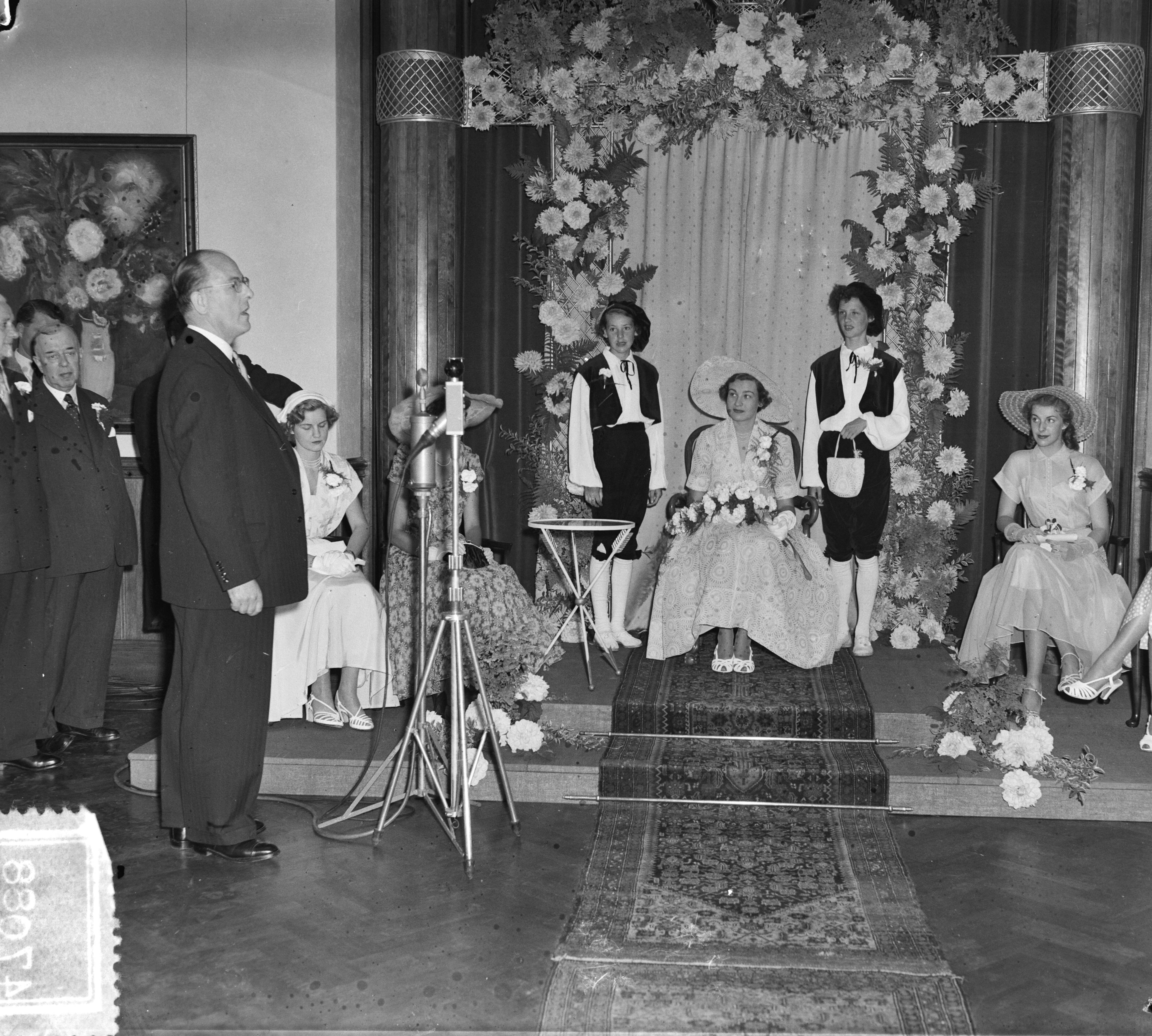 Intocht Bloemenkoningin van Den Haag — Intocht Bloemenkoningin van Den Haag. Toespraak van burgemeester F.M.A. Schokking — Foto: Pot, Harry / Anefo. Licentie: Set B: Rechtenvrij / Publiek Domein. Bron: Nationaal Archief. http://hdl.handle.net/10648/a8edcaf0-d0b4-102d-bcf8-003048976d84