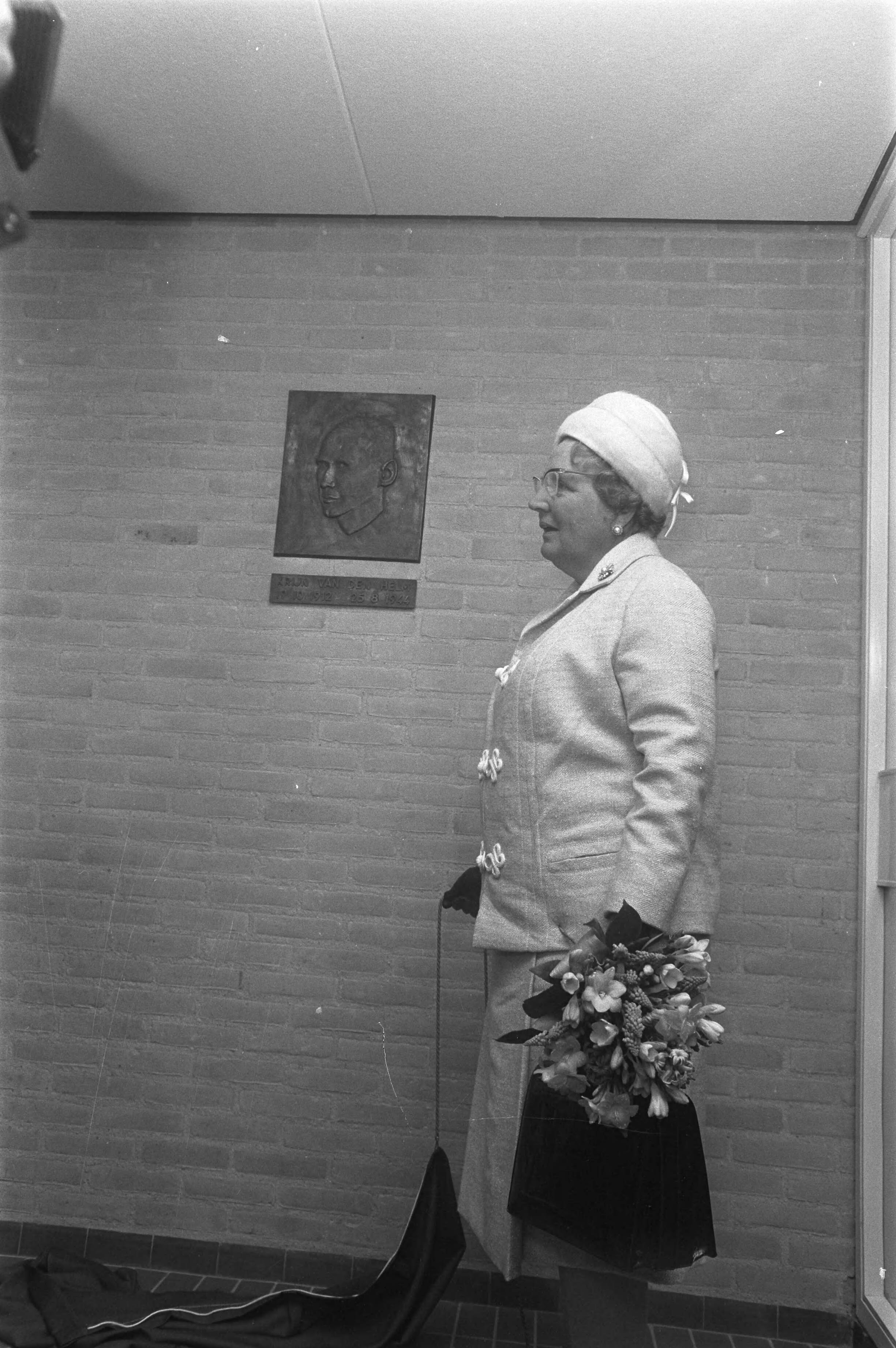 Herdenking in Leeuwarden van 25 jaar bevrijding van Friesland in aanwezigheid van koningin Juliana — Koningin Juliana onthult een plaquette ter herinnering aan de verzetsheld Krijn van der Helm (1912-1944) — Foto: Fotograaf Onbekend / Anefo. Licentie: Set B: Rechtenvrij / Publiek Domein. Bron: Nationaal Archief. http://hdl.handle.net/10648/ab943c62-d0b4-102d-bcf8-003048976d84