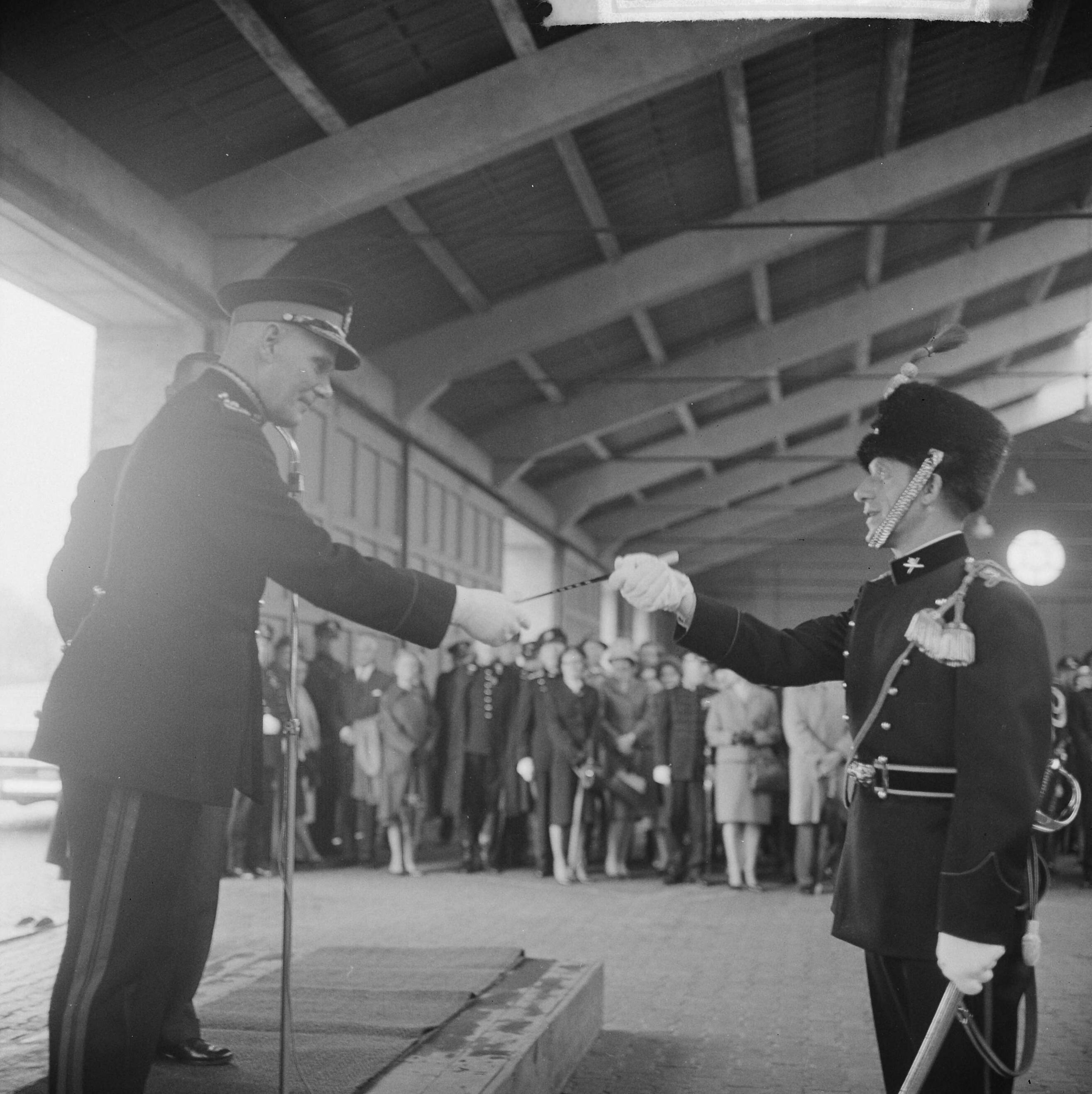 Fotocollectie Anefo — In de Chassé kazerne te Breda is het Artillerie Trompetterkorps officieel geïnstalleerd als fanfarekorps der Artillerie, door staatssecretaris J.C.E. Haex. Generaal-majoor B. Andringa overhandigd de dirigeerstok aan kapelmeester A.V. van Hoek — Foto: Koch, Eric / Anefo. Licentie: Set B: Rechtenvrij / Publiek Domein. Bron: Nationaal Archief. http://hdl.handle.net/10648/aa67a6a8-d0b4-102d-bcf8-003048976d84