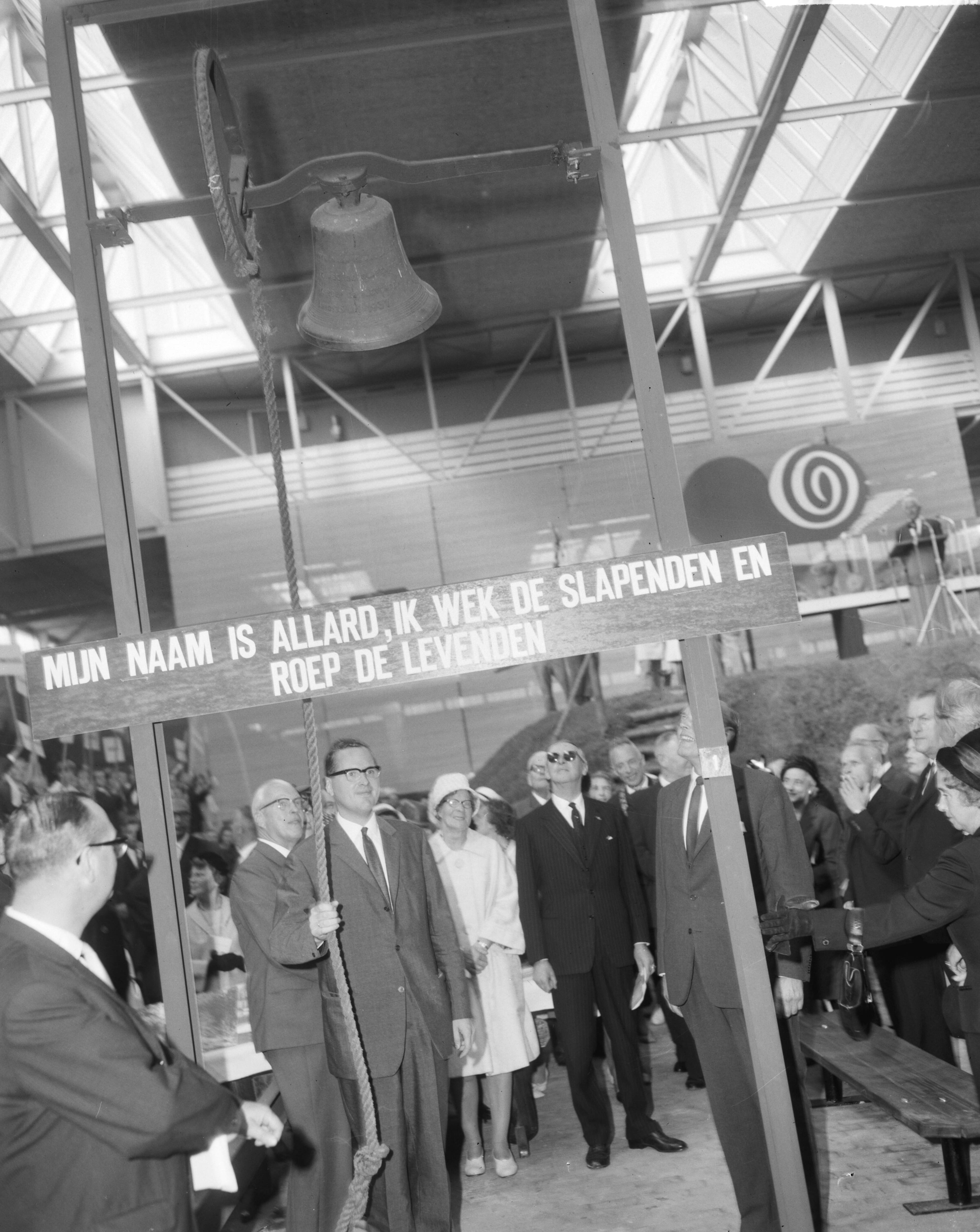 Fotocollectie Anefo — Tentoonstelling "Frisiana" te Leeuwarden officieel door minister J.E. Andriessen geopend. De mister luidt de bel — Foto: Bilsen, Joop van / Anefo. Licentie: Set B: Rechtenvrij / Publiek Domein. Bron: Nationaal Archief. http://hdl.handle.net/10648/aa458c30-d0b4-102d-bcf8-003048976d84