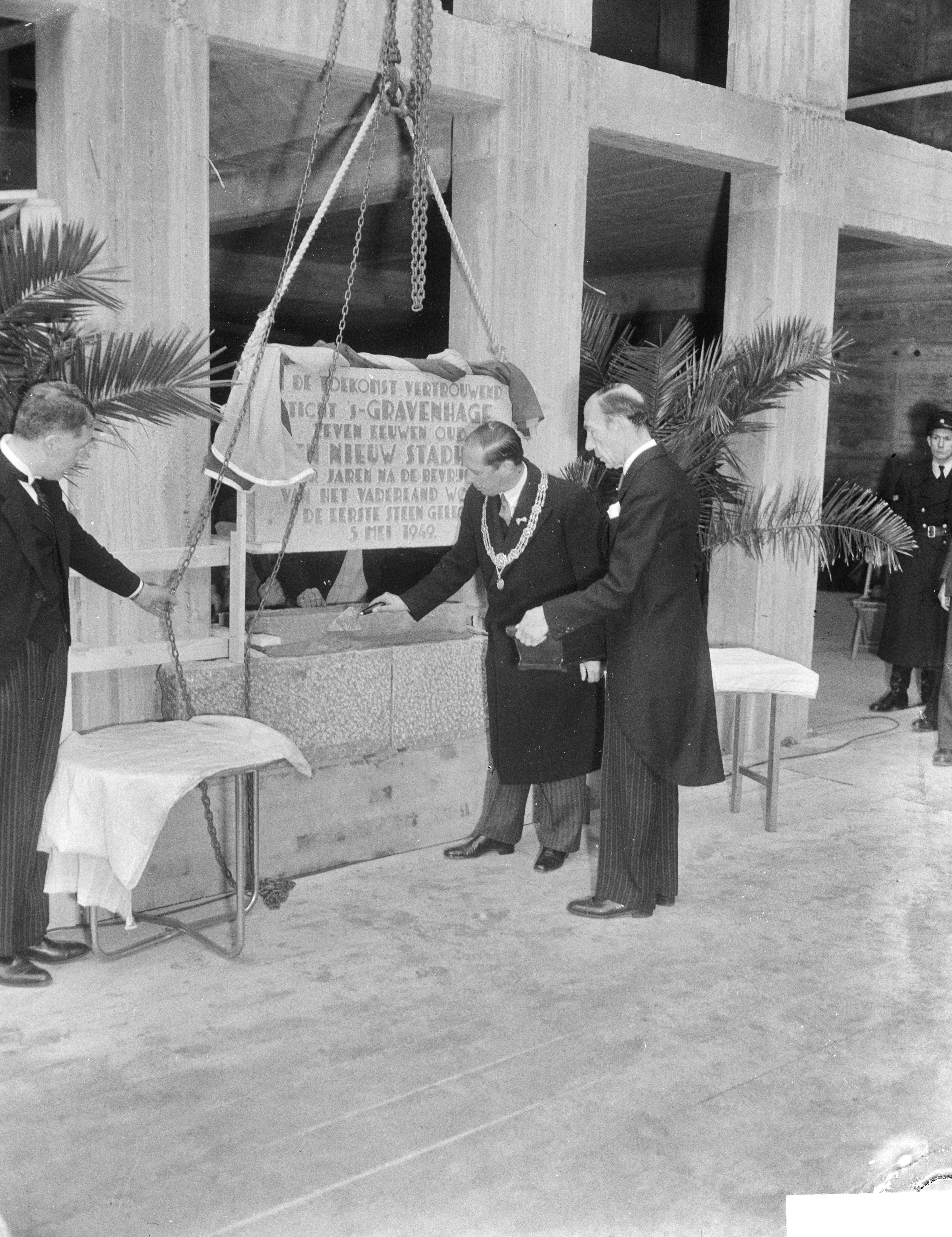 Fotocollectie Anefo — Eerste steen Stadhuis Alexanderveld Den Haag — Foto: Merk, Ben / Anefo. Licentie: Set B: Rechtenvrij / Publiek Domein. Bron: Nationaal Archief. http://hdl.handle.net/10648/a8c756cc-d0b4-102d-bcf8-003048976d84