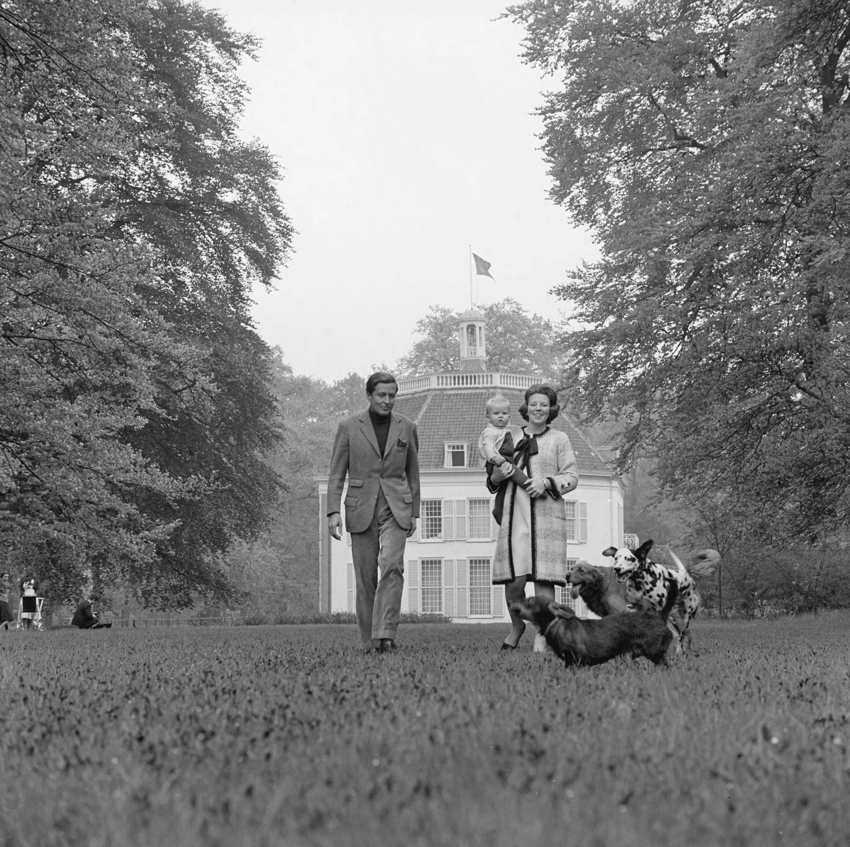 Fotocollectie RVD / Koninklijk Huis — Prinses Beatrix en prins Claus met Prins Willem-Alexander en de honden in de tuin van kasteel Drakensteyn, 1968 — Foto: Koot, Max / RVD. Licentie: Set B: Rechtenvrij / Publiek Domein. Bron: Nationaal Archief. http://hdl.handle.net/10648/afbb600e-d0b4-102d-bcf8-003048976d84