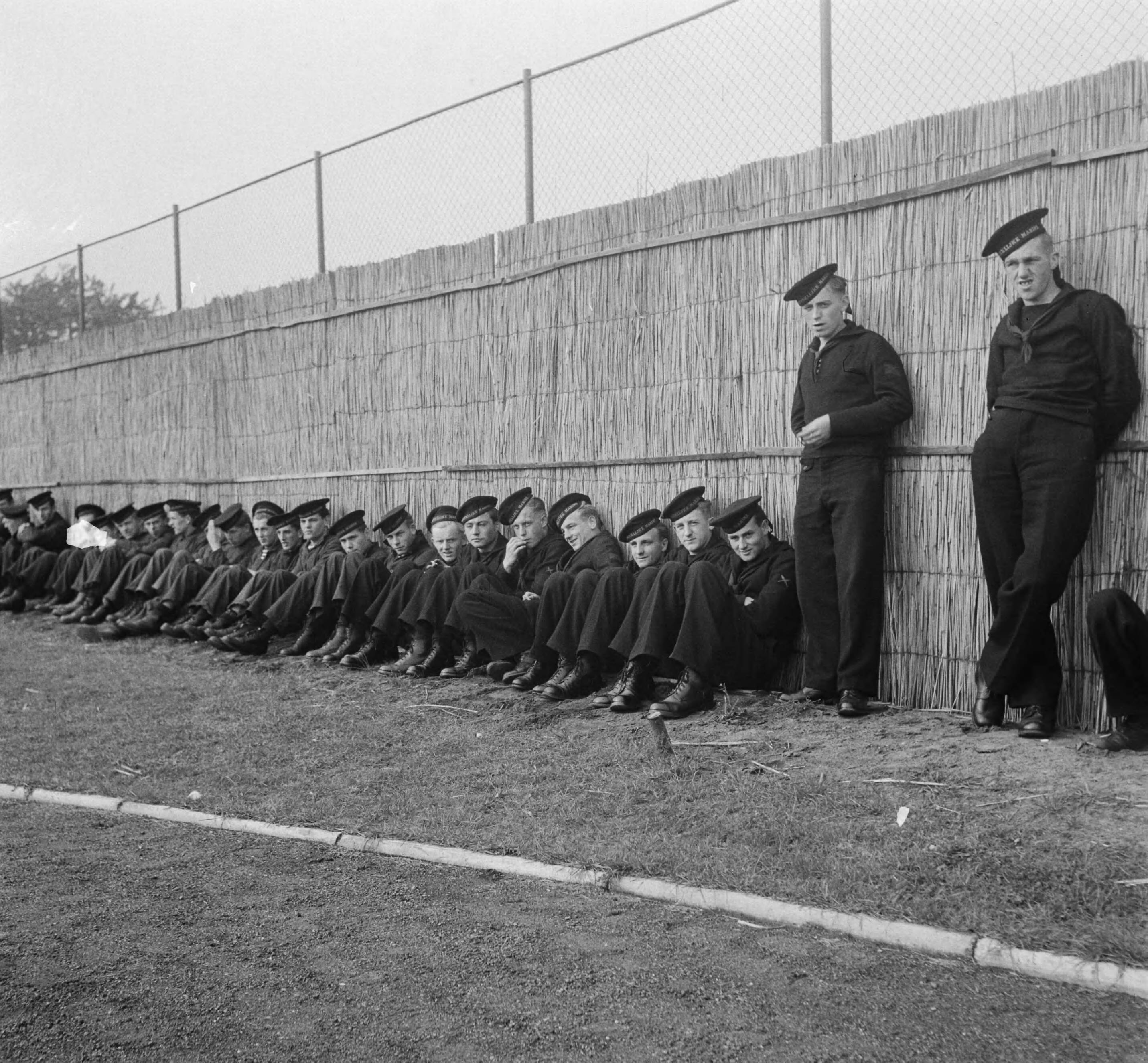 MOK Hilversum 1948 — MOK Hilversum. Matrozen tegen rieten achtergrond — Foto: Steenkamp, B.J.J. (Ben) / Anefo. Licentie: Set B: Rechtenvrij / Publiek Domein. Bron: Nationaal Archief. http://hdl.handle.net/10648/a8bd9e5c-d0b4-102d-bcf8-003048976d84