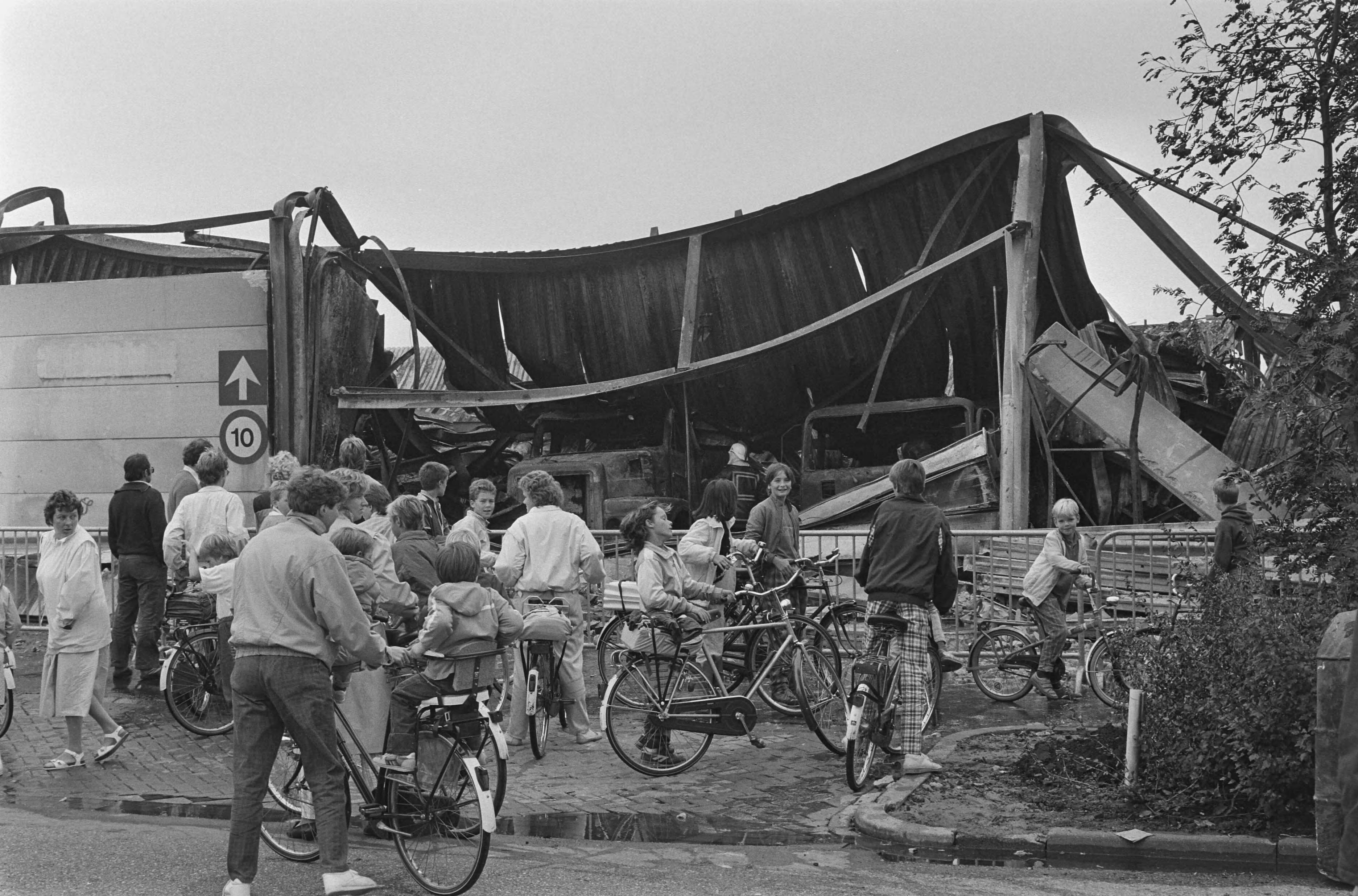 Fotocollectie Anefo — Verbrande vrachtwagens na brand in goederen-overslagbedrijf in Bodegraven; publieke belangstelling — Foto: Croes, Rob C. / Anefo. Licentie: Set B: Rechtenvrij / Publiek Domein. Bron: Nationaal Archief. http://hdl.handle.net/10648/ad56c9de-d0b4-102d-bcf8-003048976d84
