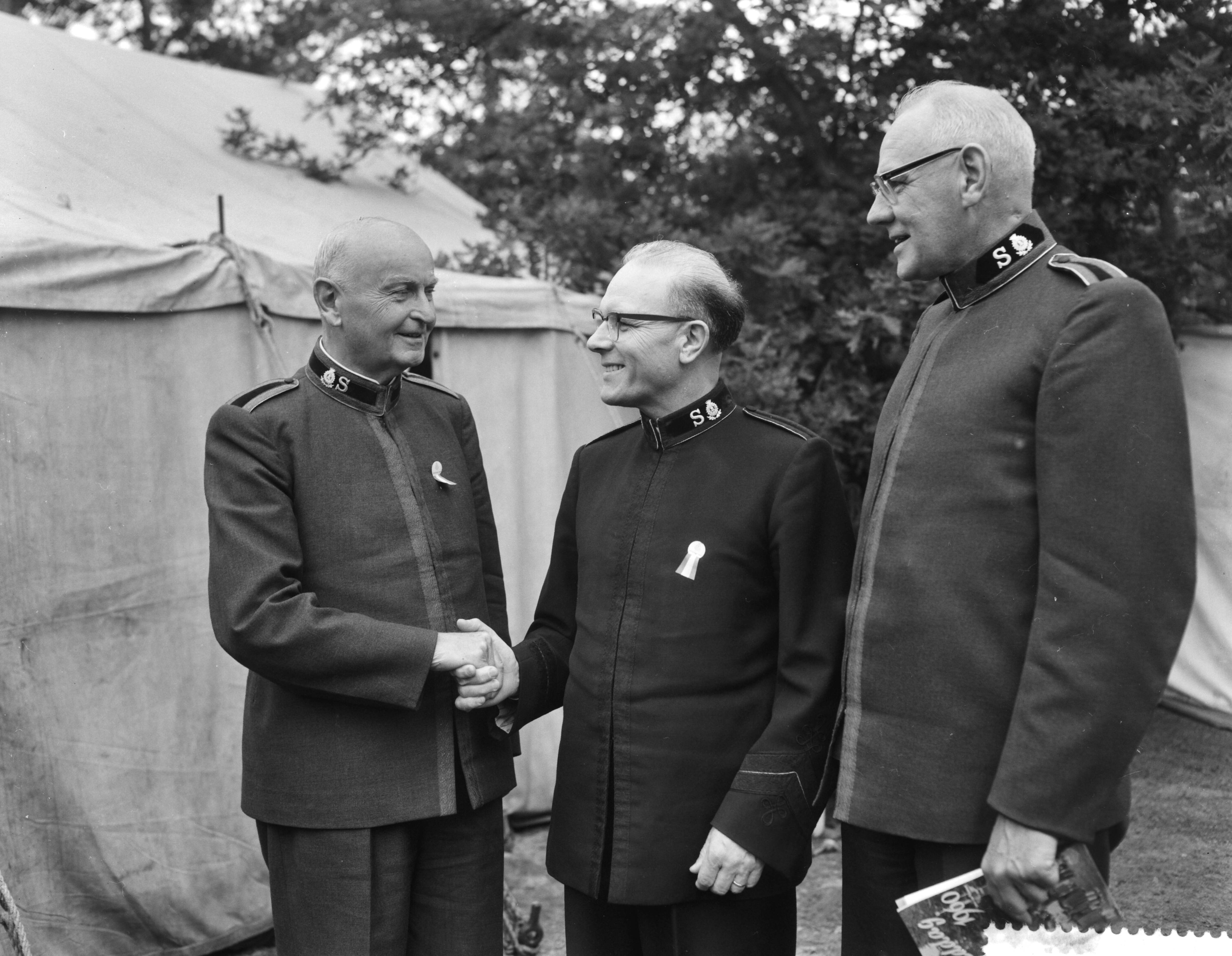 Fotocollectie Anefo — Nationale Velddag van het Leger des Heils in het Kroondomein Baarn. Vlnr. commissioner E.C. Thykjaer, commissioner Norman F. Duggins en kommandant W.F. Palstra — Foto: Bilsen, Joop van / Anefo. Licentie: Set B: Rechtenvrij / Publiek Domein. Bron: Nationaal Archief. http://hdl.handle.net/10648/a9b1da62-d0b4-102d-bcf8-003048976d84