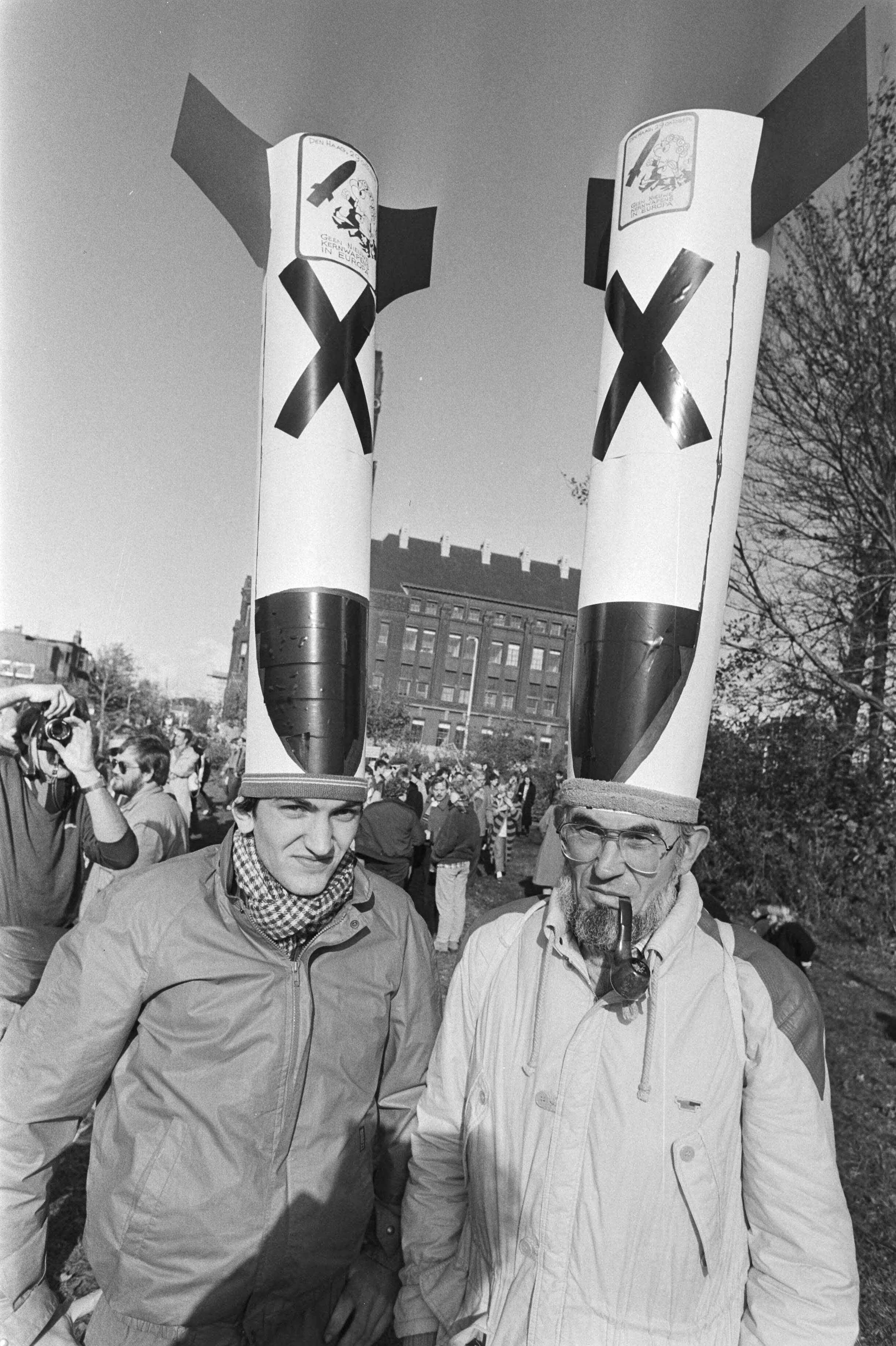 Vredesdemonstratie Den Haag , 550.000 mensen demonstreren o.m. tegen plaatsing kruisrakette — Demonstranten met kruisraketten als muts op het Malieveld — Foto: Bogaerts, Rob / Anefo. Licentie: Set B: Rechtenvrij / Publiek Domein. Bron: Nationaal Archief. http://hdl.handle.net/10648/ad2fdb4e-d0b4-102d-bcf8-003048976d84