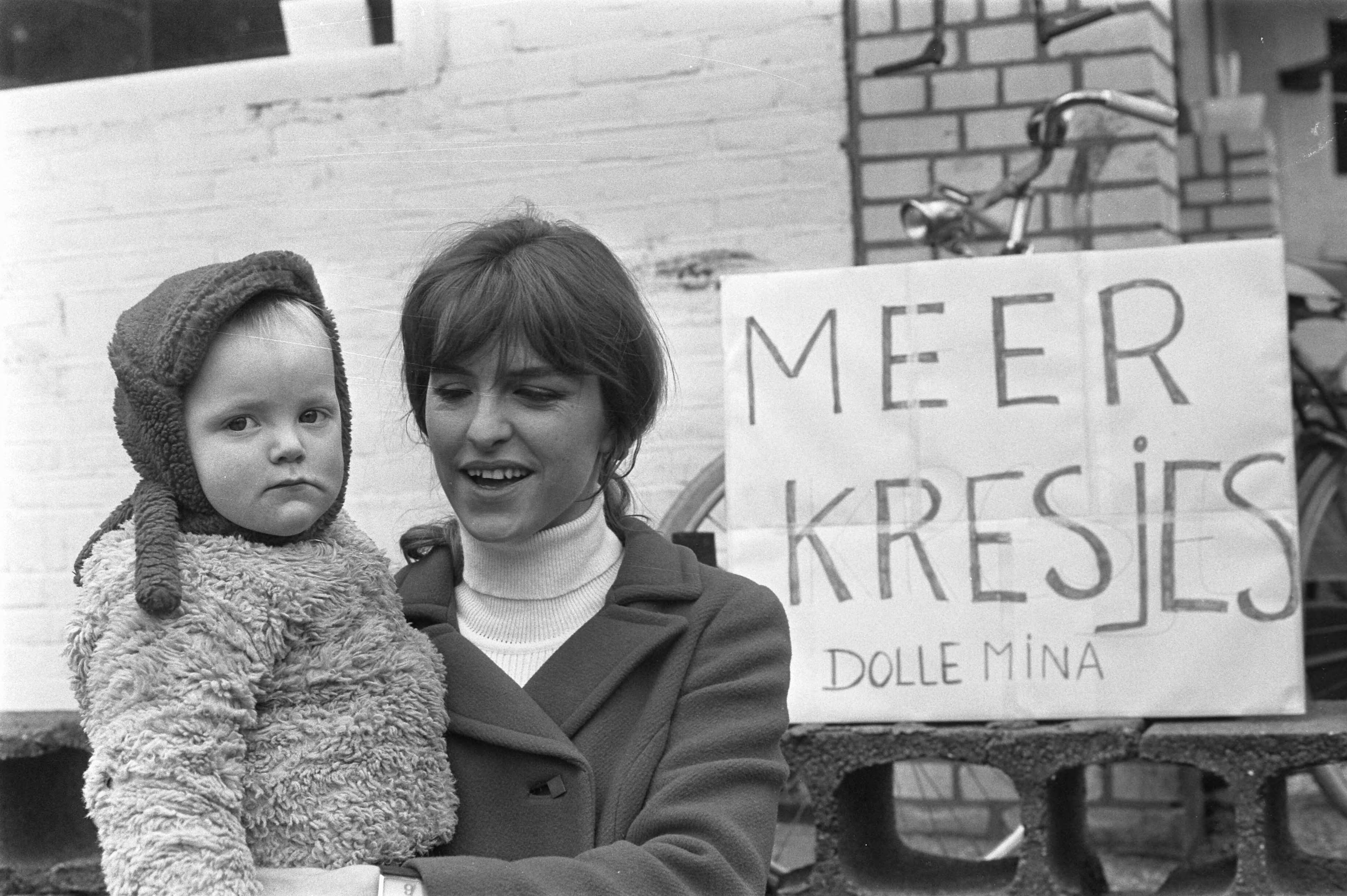Dolle Mina Annemie Souren — Souren met een bord 'Meer kresjes', Huizen — Foto: Mieremet, Rob / Anefo. Licentie: Set B: Rechtenvrij / Publiek Domein. Bron: Nationaal Archief. http://hdl.handle.net/10648/ab939014-d0b4-102d-bcf8-003048976d84